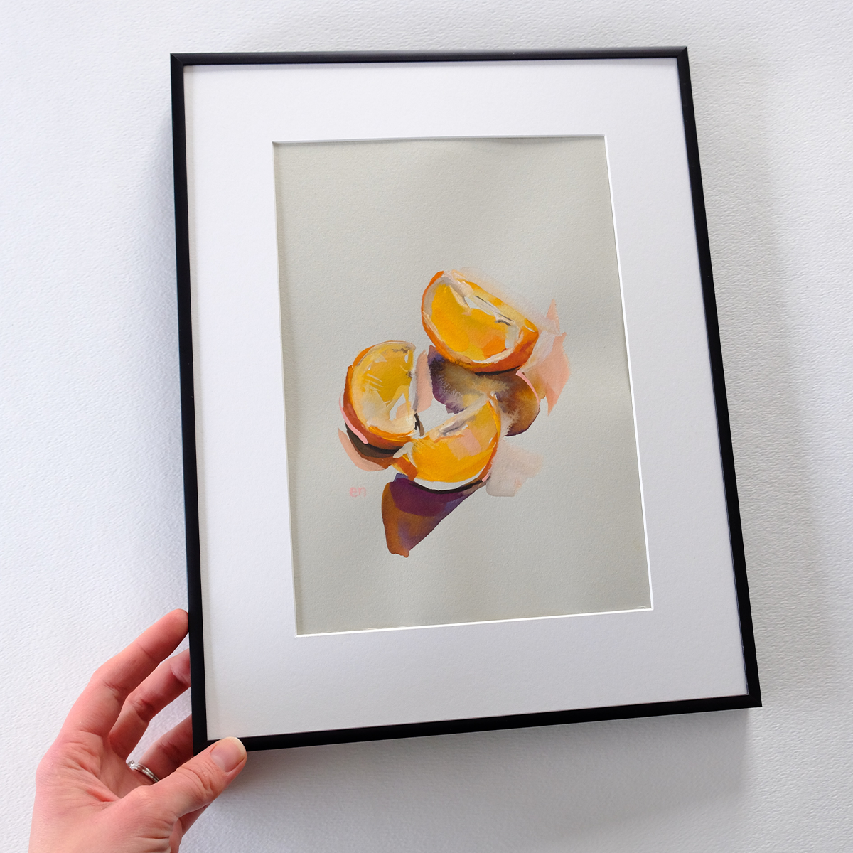 Oranges in January framed in hand.png