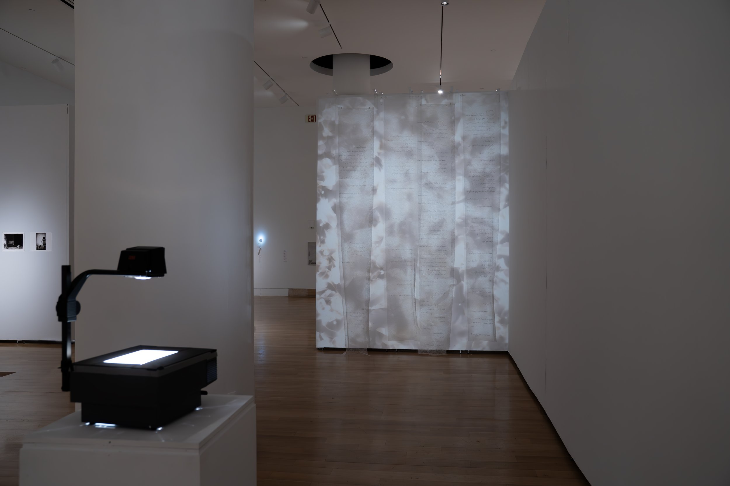 Zahra Momeni ,
Your Trace in the Farthest Nearness, 
2026, 
Mixed-media installation with overhead  
projection, photograms, transparent fabric,  
and handwritten text. 
Dimensions variable 