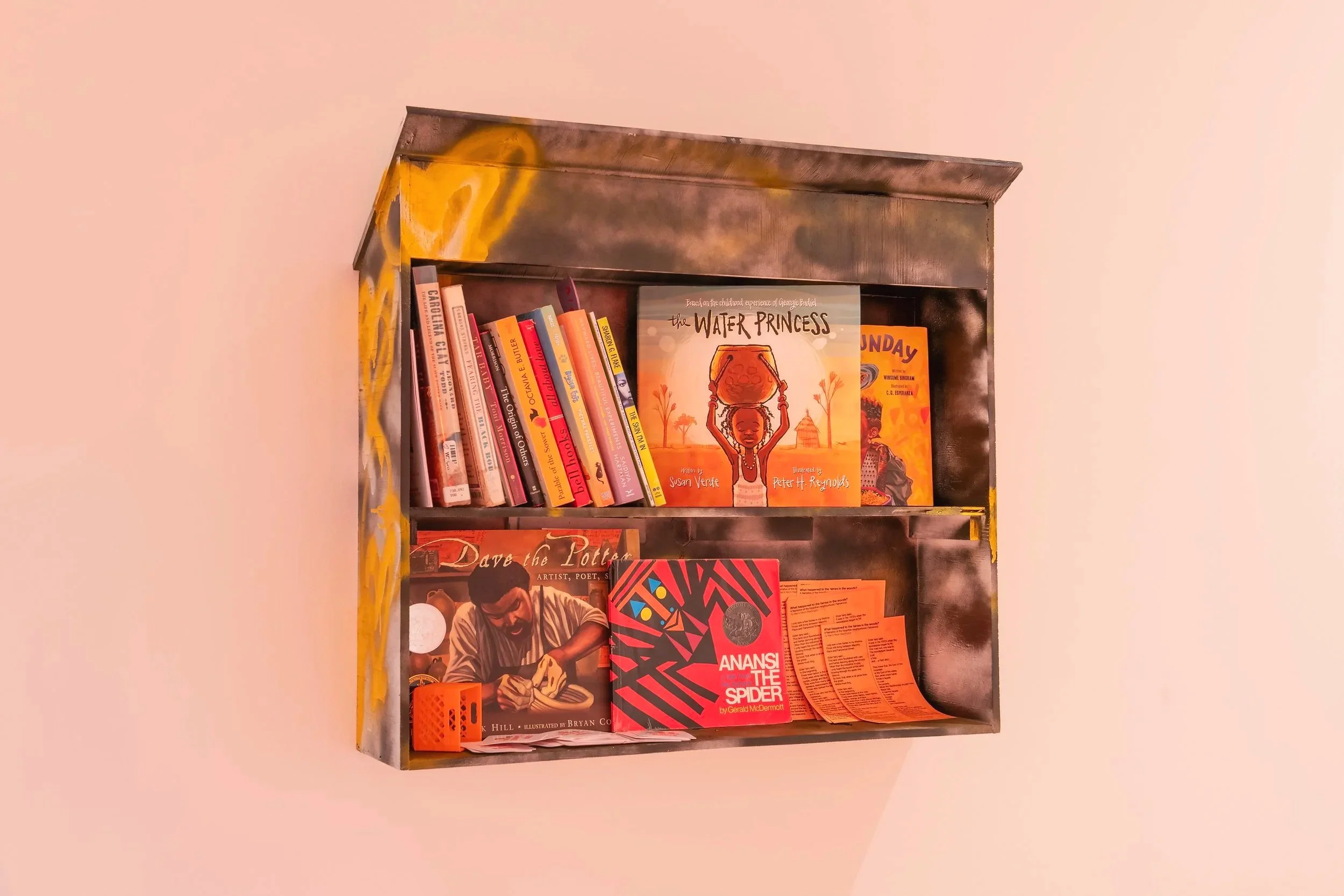 "Little Library," Wood, spray paint, poem "What happened to the fairies in the woods" and various books, 18" by 24" Photo Credit: John Carlano