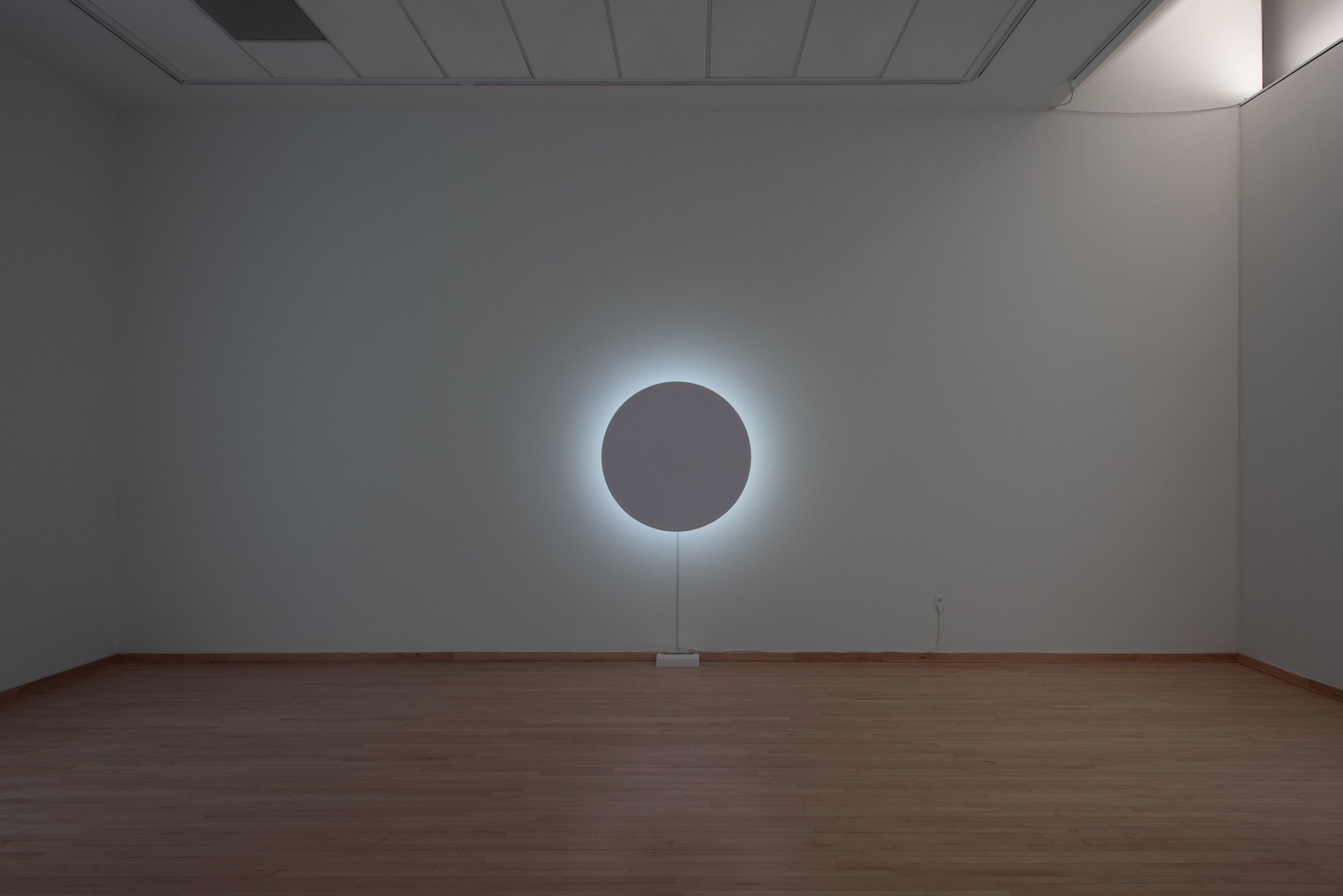 "In Totality" (still), 2025, Time-based installation view showing “Optic Disc (Red),” Retroreflective glass microspheres, acrylic paint, foam, steel, LED light, computer controller, 46” by 46” by 14” Photo credit: Neighboring States