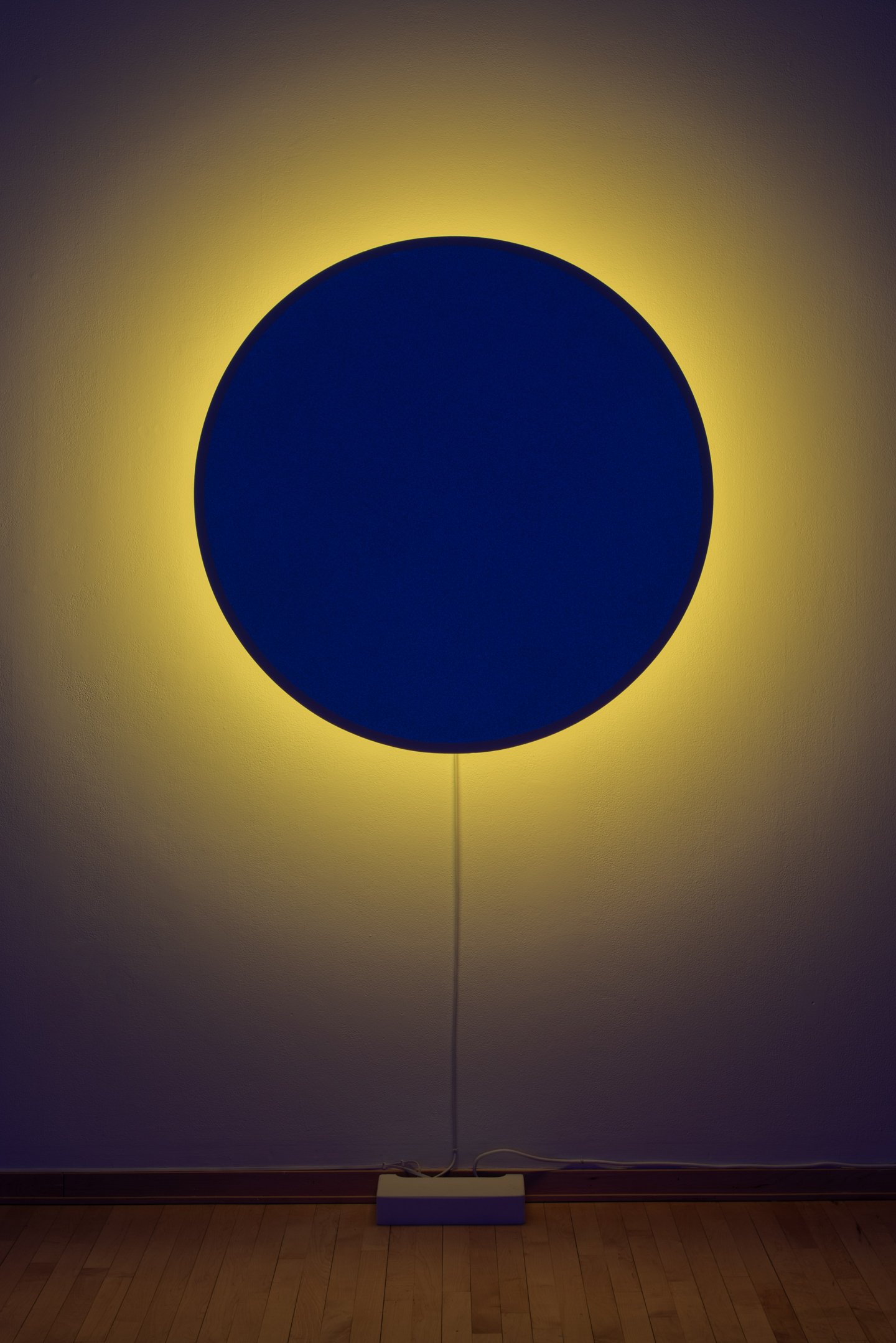 "In Totality" (still), 2025,
Time-based installation view showing “Optic Disc (Yellow)”
Retroreflective glass microspheres, acrylic paint, foam, steel, LED light, computer controller. 46” by 46” by 14”
Photo credit: Neighboring States