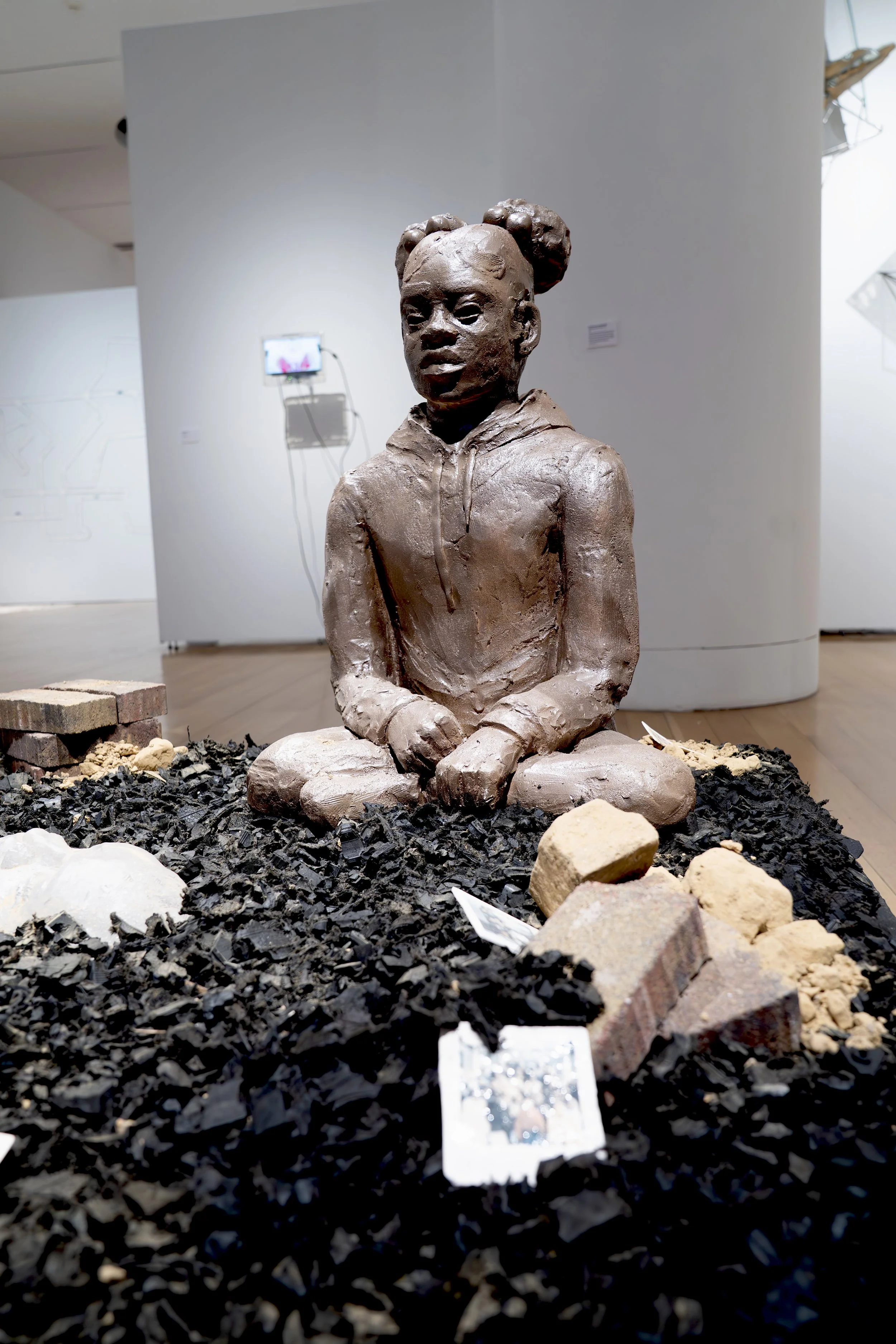 Marcè Nixon-Washington, 
Those abandoned lots for sale... 
2026, 
Stoneware, porcelain, locally dug clay (Temple  
University Campus), mudcloth fabric (cotton,  
black tea, and locally dug clay), kiln-cast glass,  
bricks. Image reference: Heinz Hist