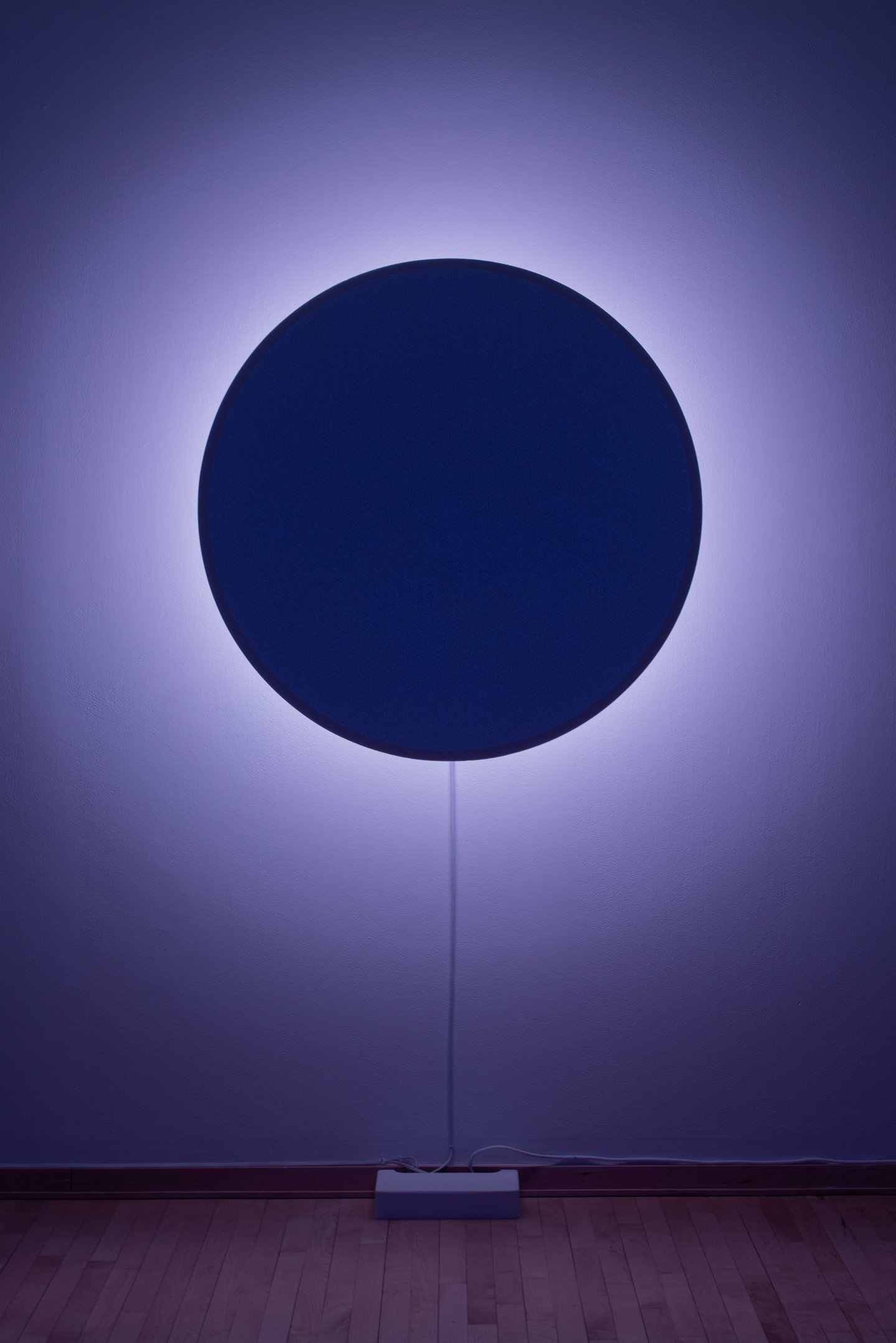 "In Totality" (still), 2025,
Time-based installation view showing “Optic Disc (Yellow)”
Retroreflective glass microspheres, acrylic paint, foam, steel, LED light, computer controller. 46” by 46” by 14”
Photo credit: Neighboring States