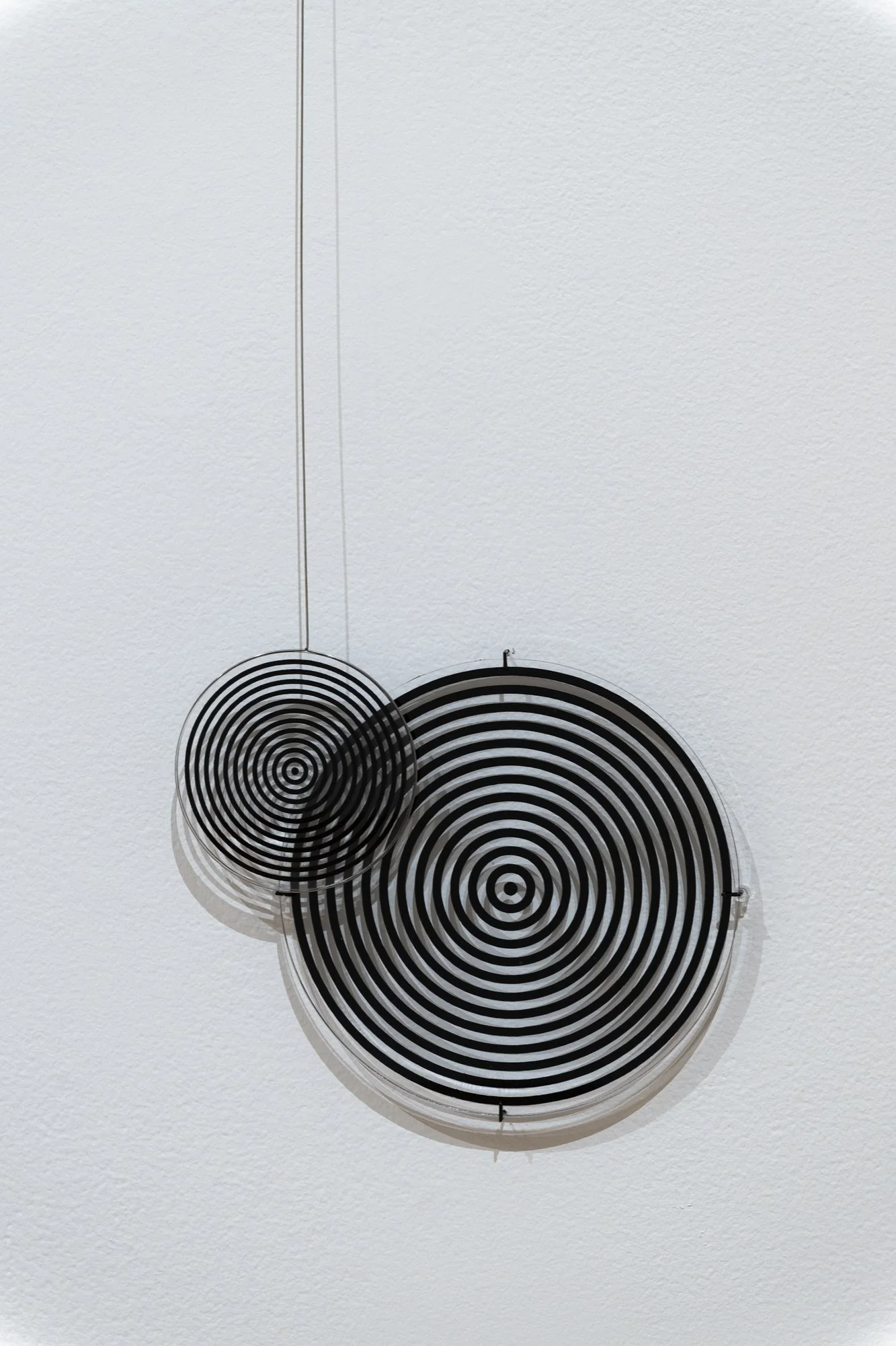 "Moiré Pendulums," (detail), Acrylic, vinyl, steel wire. Dimensions variable. Photo Credit: Sam Fritch