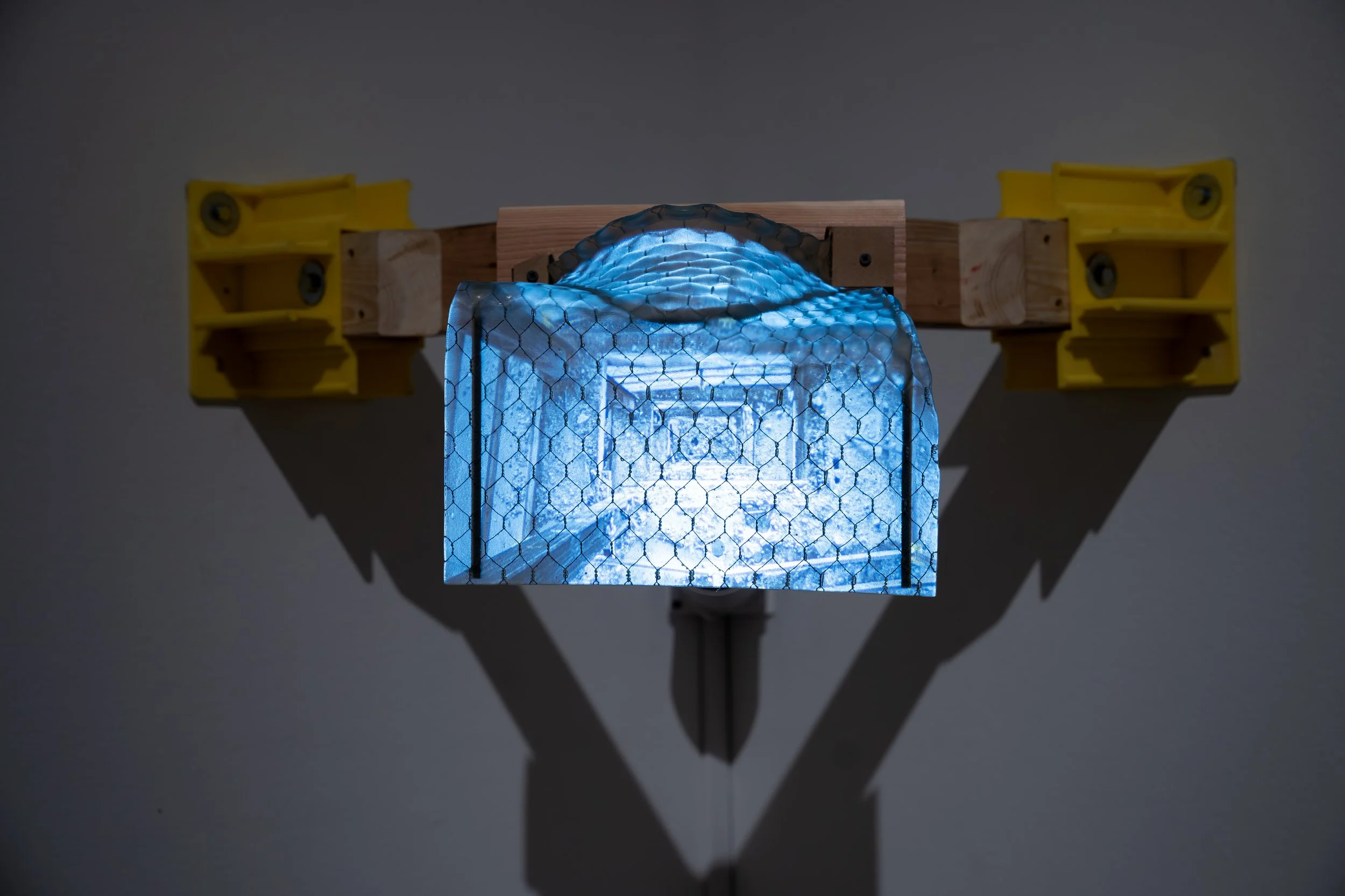 Maximilian Art Boyce, 
Threshold Adrift, 
2026, 
Single-channel video projection (4:45); safety  
glass, wood, steel, and plastic. 
27" x 27" x 14"