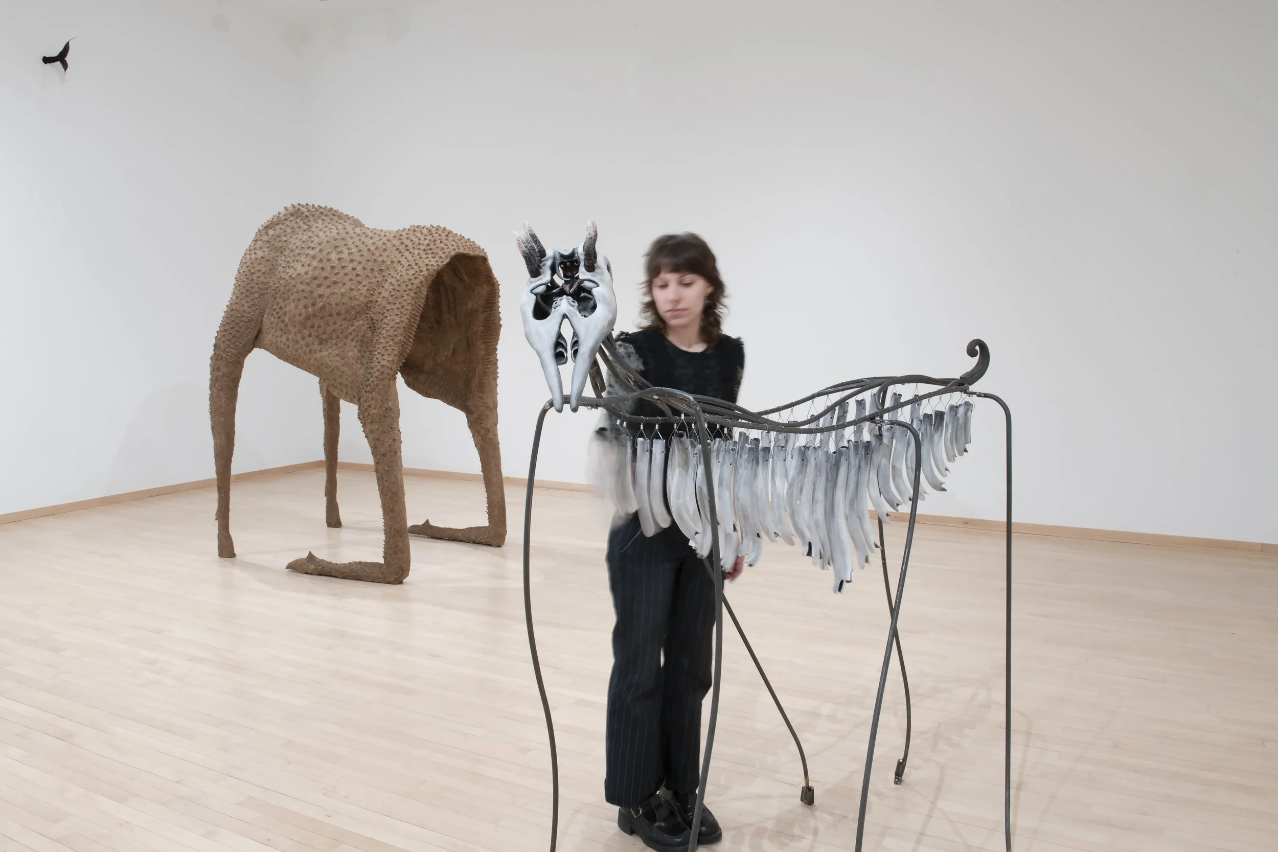 “Chimes Horse”, Installation view
(in motion), Cardboard pulp, glue, chicken wire, wood, pvc, ceramic,
underglaze, steel, wool. Photo Credit: John Carlano