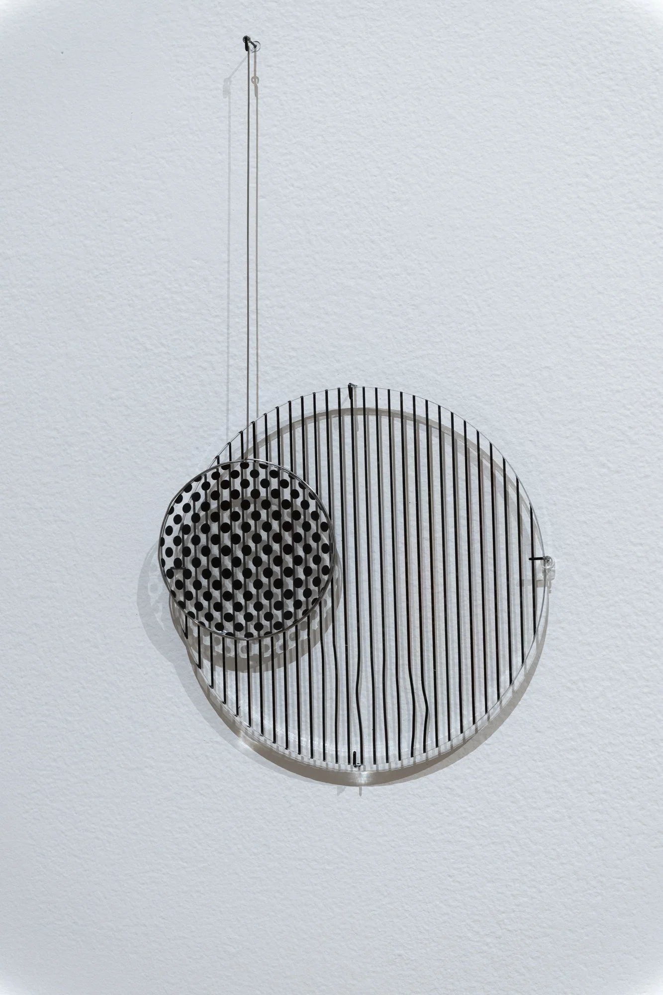 "Moiré Pendulums," (detail), Acrylic, vinyl, steel wire. Dimensions variable. Photo Credit: Sam Fritch