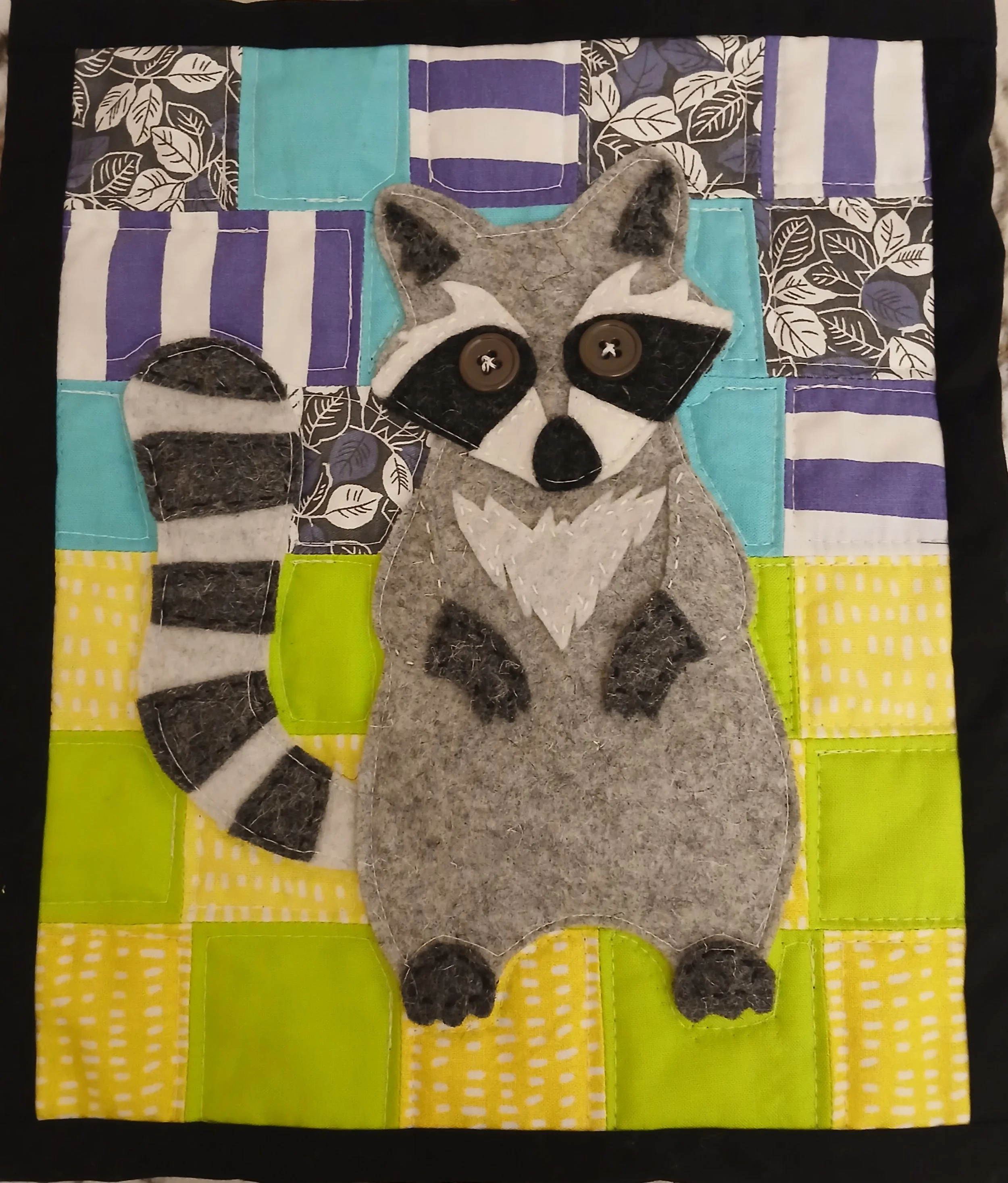 "Raccoon" 2023, cotton and felt quilt, 8”x10"
