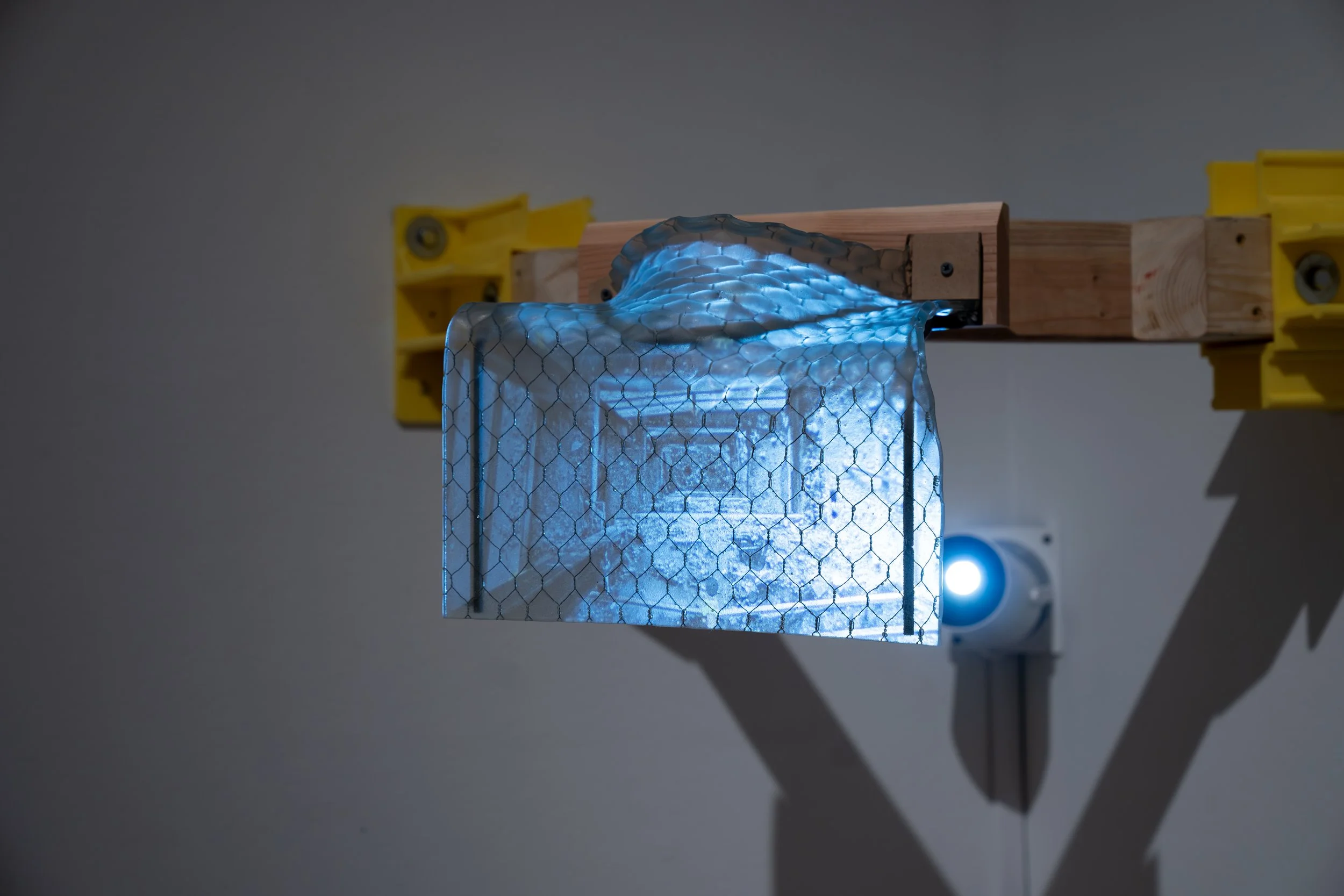 Maximilian Art Boyce, 
Threshold Adrift, 
2026, 
Single-channel video projection (4:45); safety  
glass, wood, steel, and plastic. 
27" x 27" x 14"