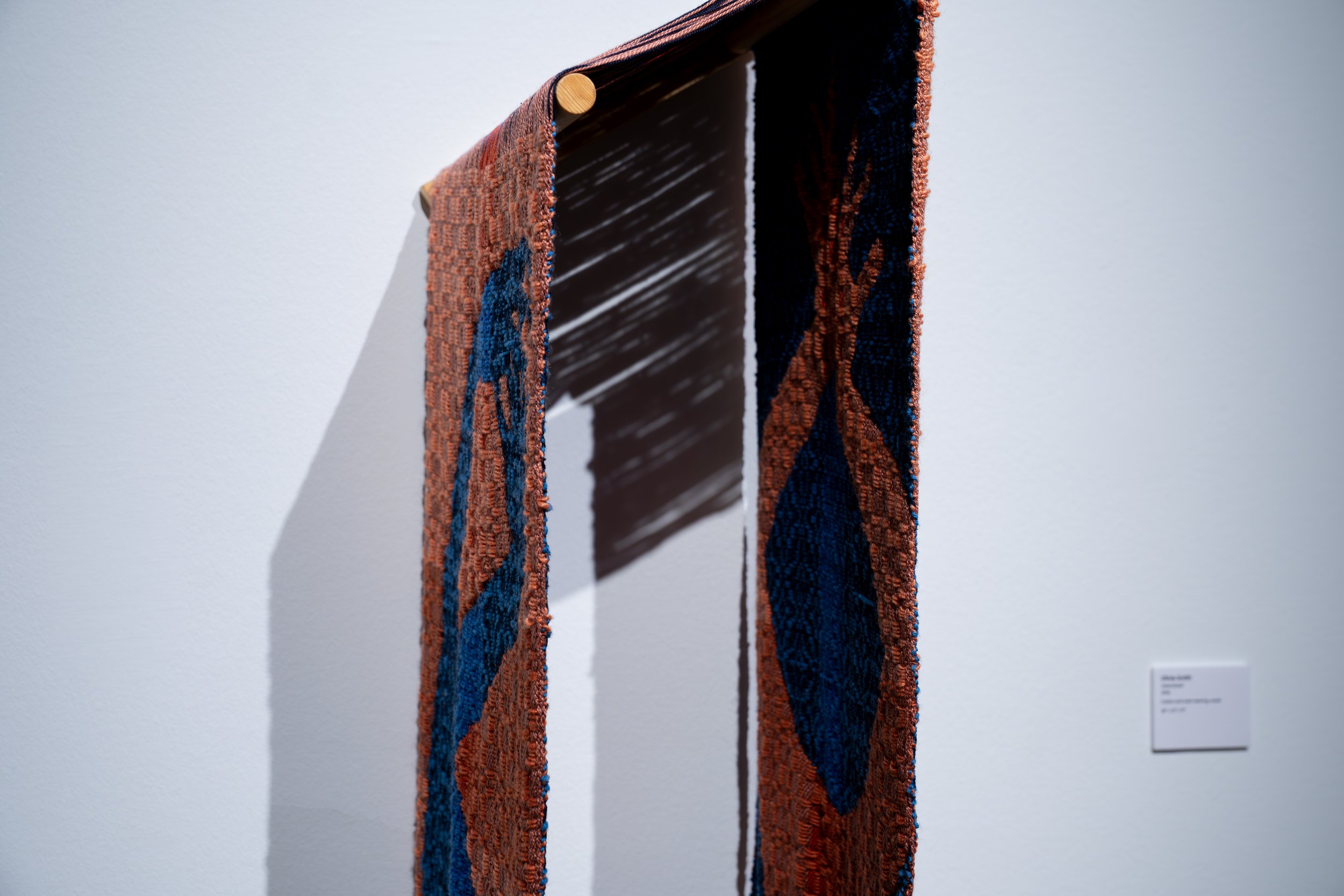 Olivia Smith,
Intertwined, 
2026, 
Cotton and wool weaving, wood. 
36" x 12" x 17" 