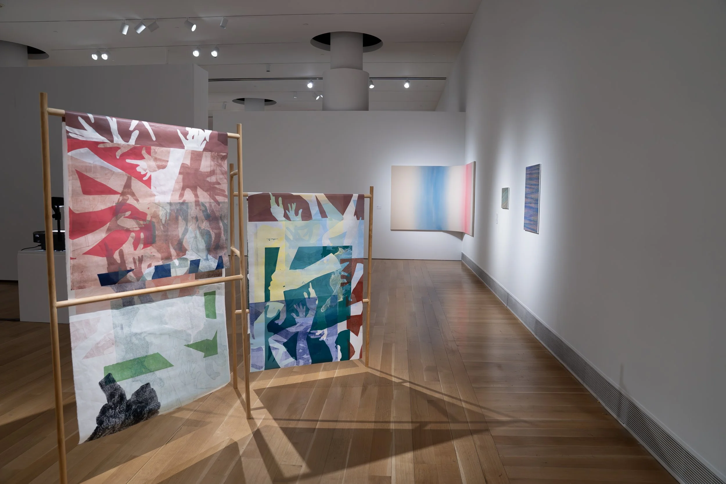 Olivia Smith, 
Frantic Hands, 
2026, 
Monoprint on mulberry paper, wood. 
62" x 110" x 12"