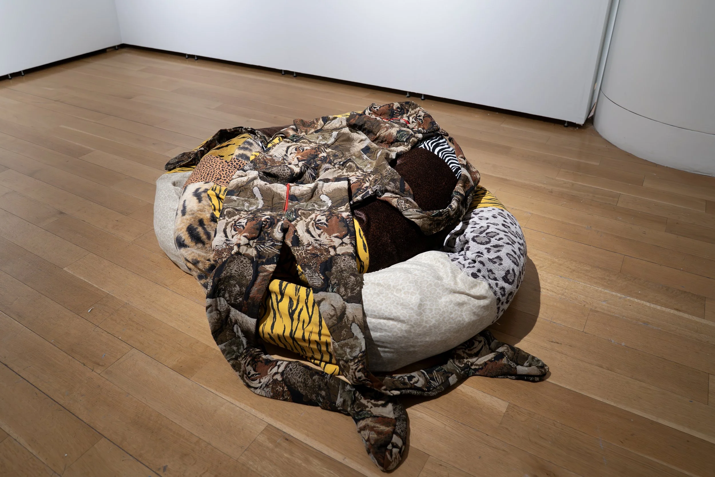 Joseph E. Malson, 
One Blue Pussy (Shadow), 
2026, 
Found material, thread. 
Dimensions variable 