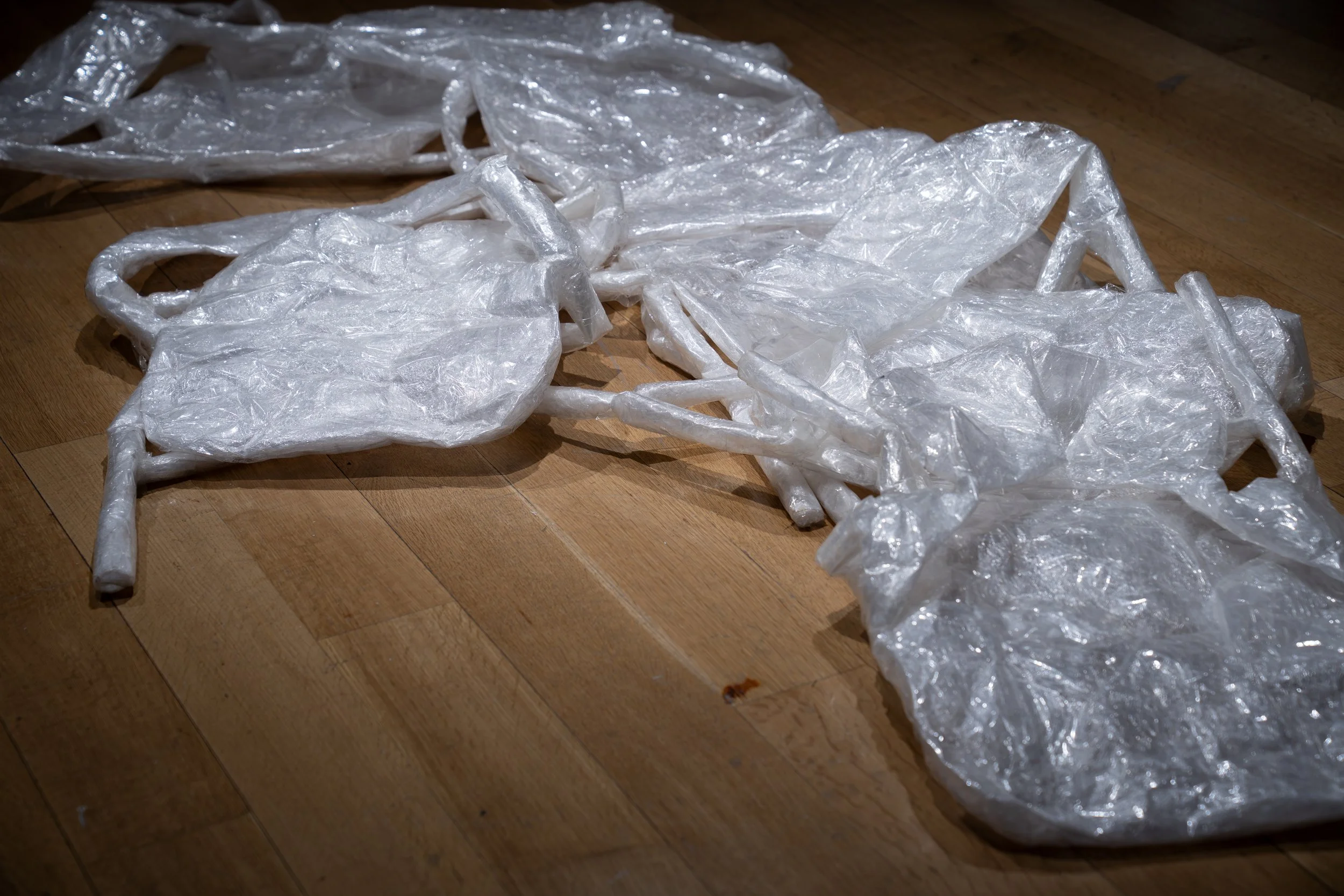 ev Leto, 
Untitled, tape chairs (front) ,
2024-2025, 
Packing tape. 
Dimensions variable 