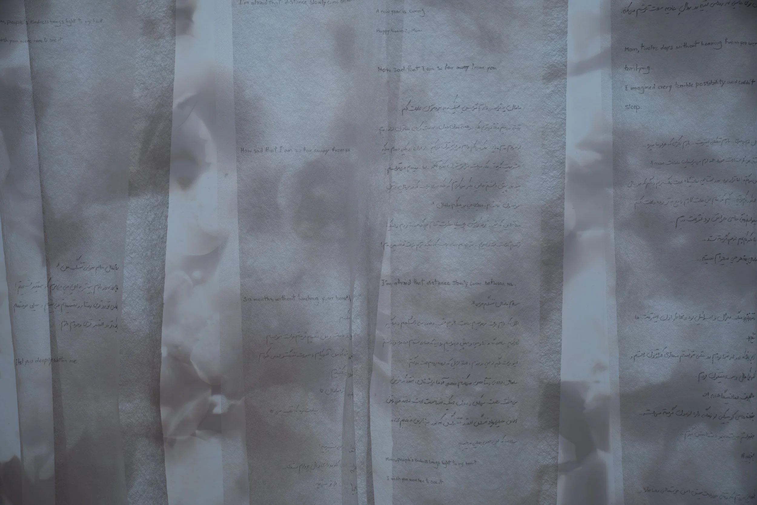 Zahra Momeni ,
Your Trace in the Farthest Nearness, 
2026, 
Mixed-media installation with overhead  
projection, photograms, transparent fabric,  
and handwritten text. 
Dimensions variable 
