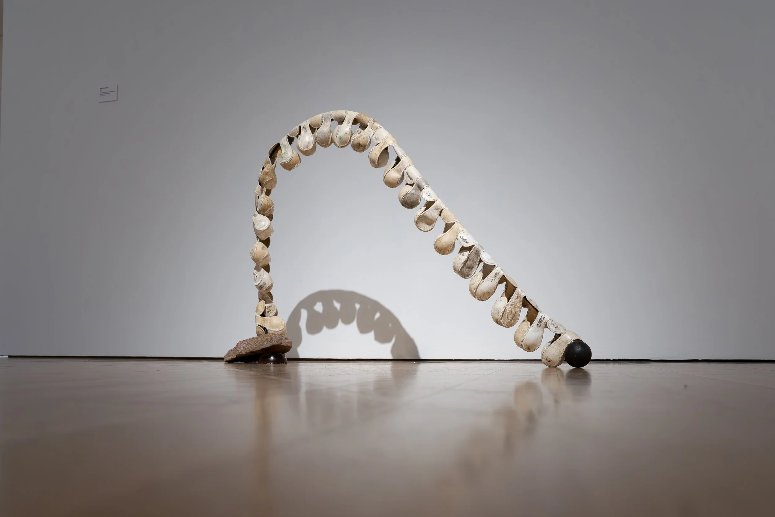 Mary Champagne, 
Spine, 
2026, 
Leather, silk, granite, steel, ball bearings, pine  
rosin, Darth Vader house key. 
42" x 10" x 36" 