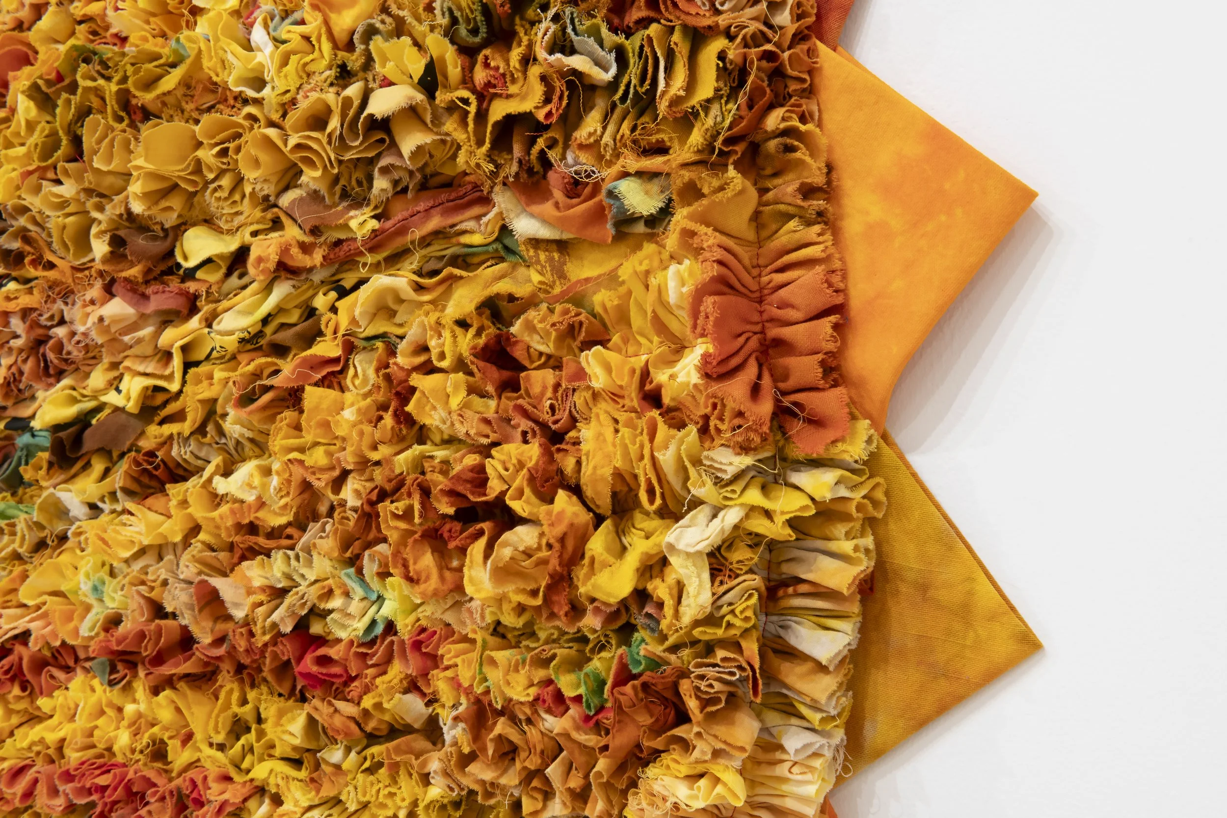 "O-Face" (detail)
cotton fabric shreds, scraps, slivers, and rags collected from artist’s practice, donation bins, and trash cans in Tyler; overdyed yellow. 64” x 64”. Photo Credit: John Carlano