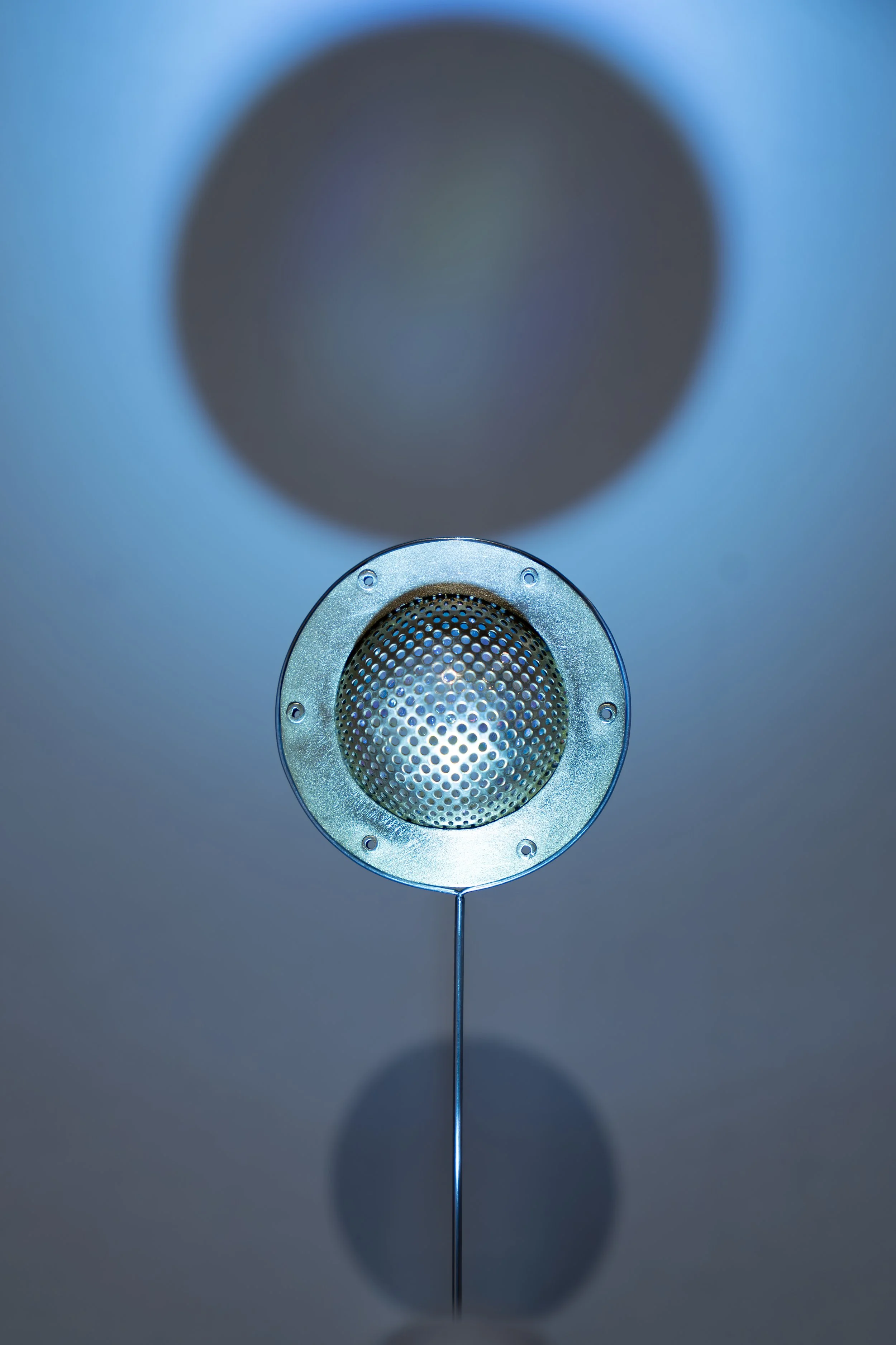 Ananda Voecks, 
Split Dome Brooch, 
2026,
Brass, acrylic, glass, steel wire. 
1 5/8" x 1 5/8" x 3/4" 