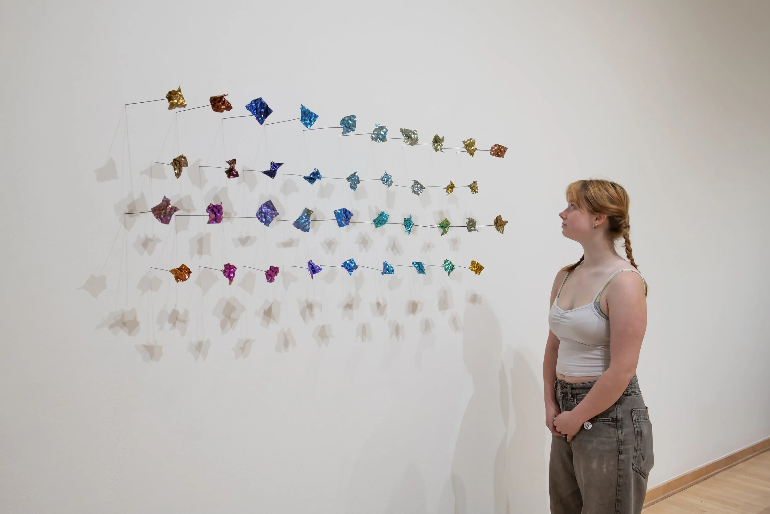 "Quiet fragments: (38 brooches made with anodized titanium and niobium)"
Titanium, Niobium, gold foil. Dimensions variable: 38 pieces in total, individual one is around 
2.7”x1.5”x0.007” 
Photo credit: John Carlano
