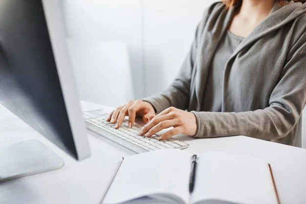 working-hard-cropped-shot-woman-typing-keyboard-sitting-front-computer-monitor-freelancer-translating-new-project-writing-some-notes-note-pad_176420-8695.jpeg