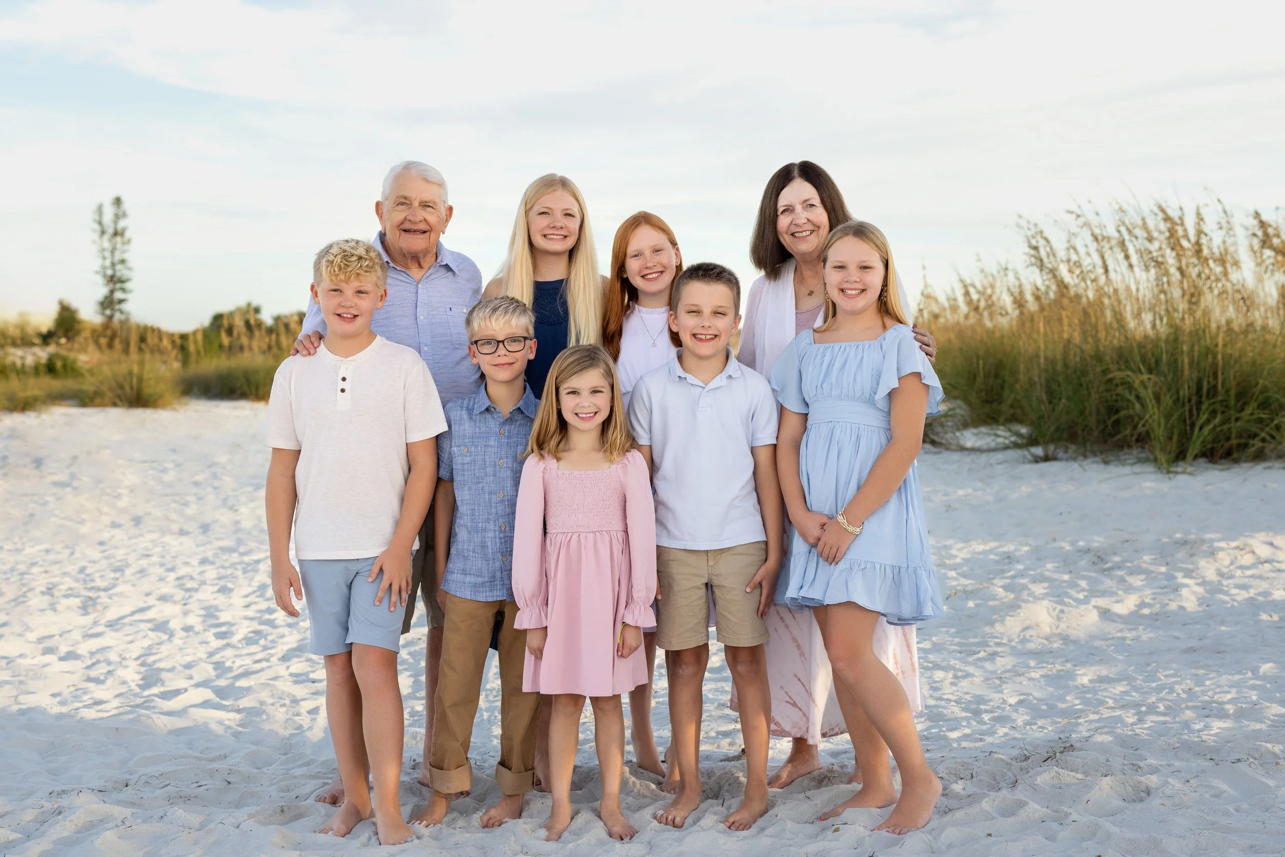 Grandparents pose with grandchildren on anna maria island, FL beach