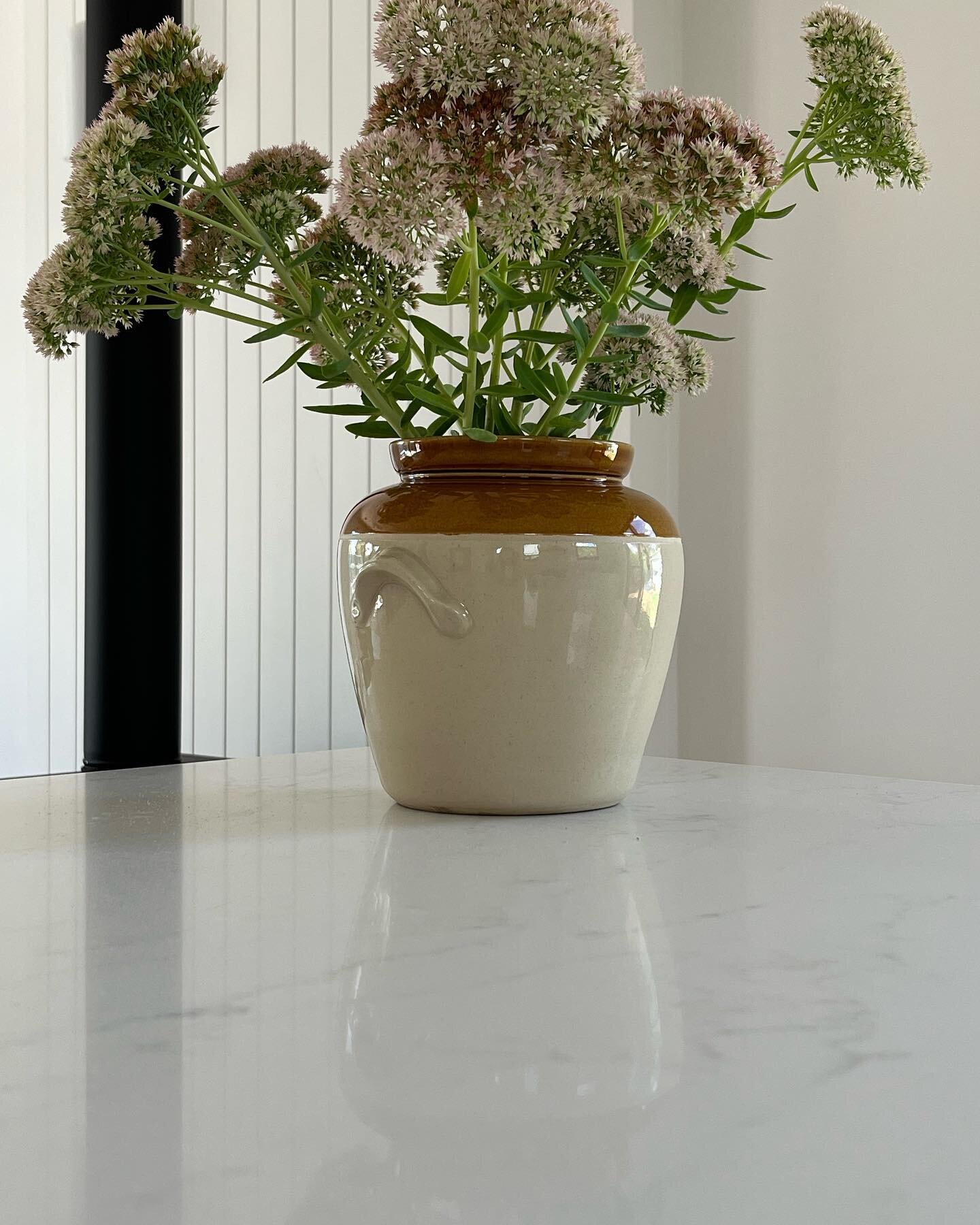 Sedum from the garden on my kitchen island today.
I purposely hung my island pendant lights higher than normal so I could have differing heights of vases and pots full of flowers or foliage.
When considering an island for your home consider how you w
