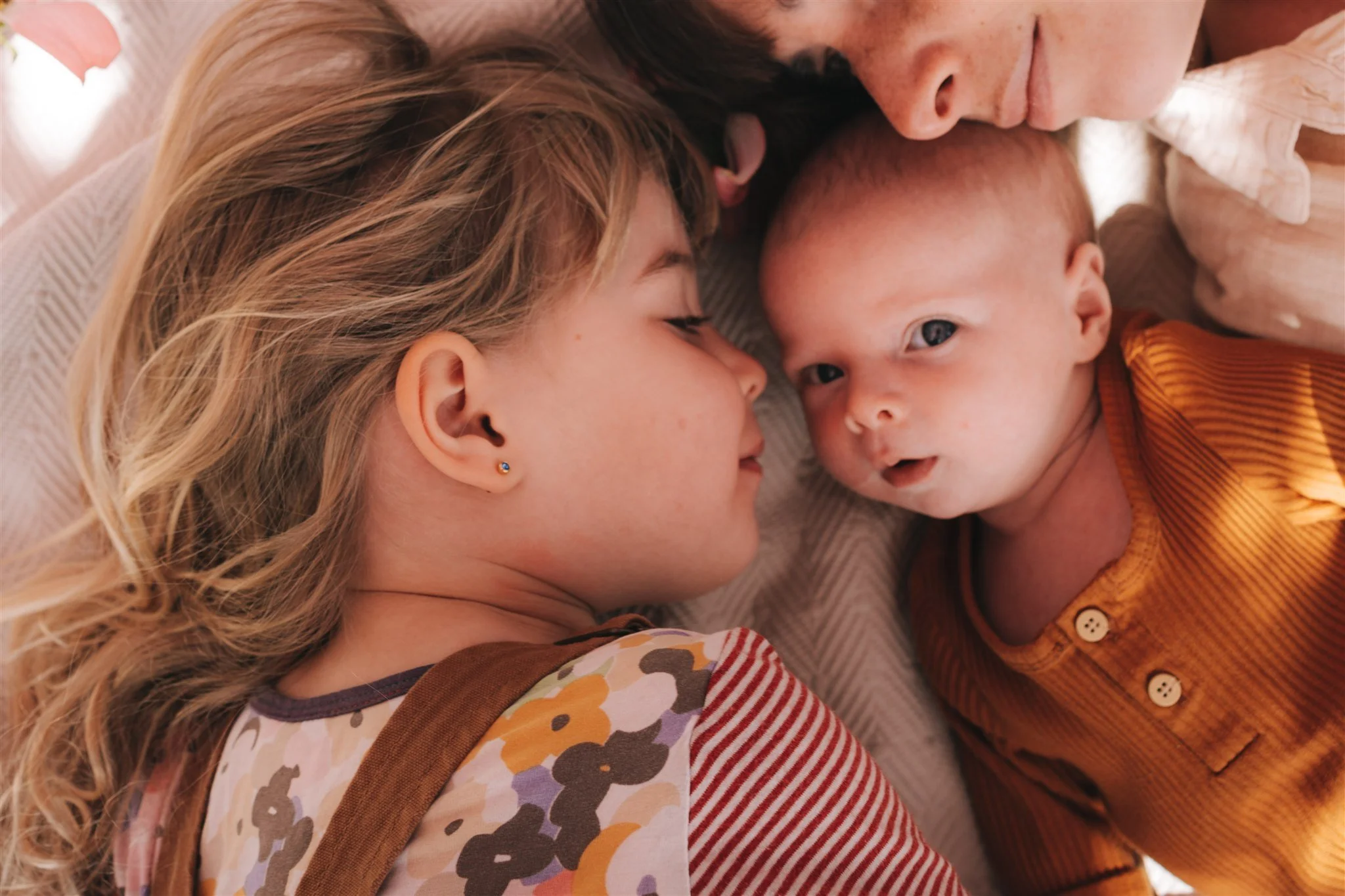 newborn and toddler lying on rug in bright Victoria