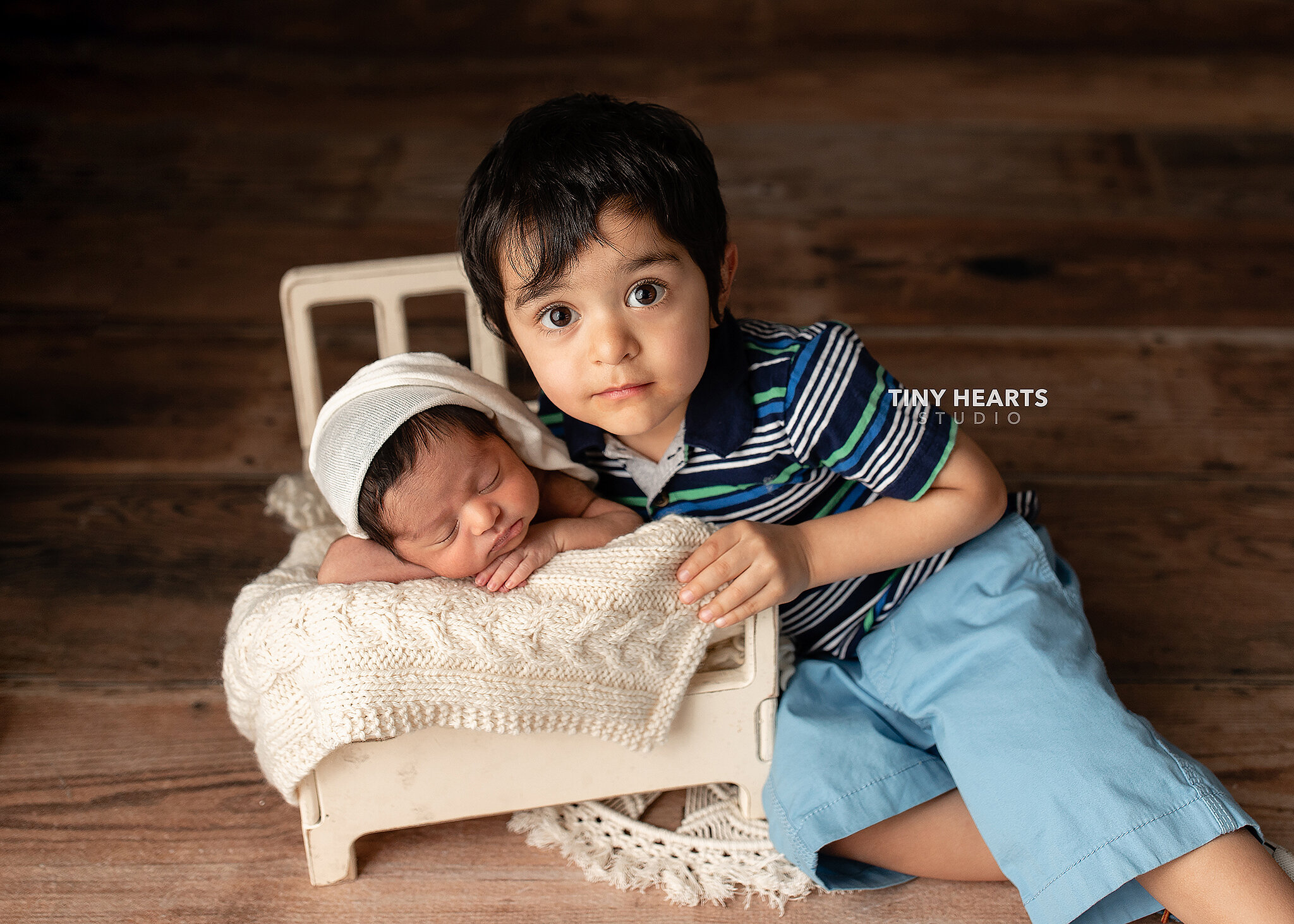 older brother with newborn sister