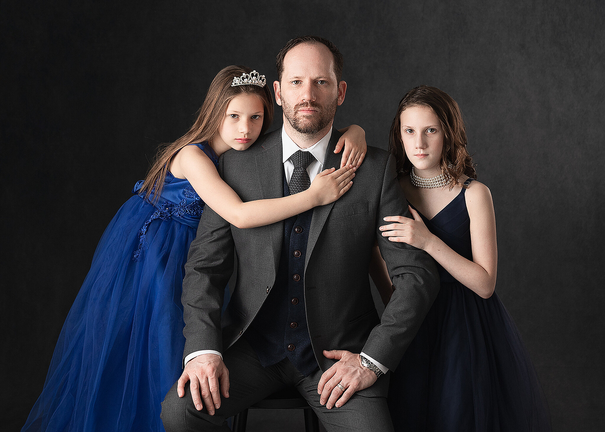 father and daughters in formal attire