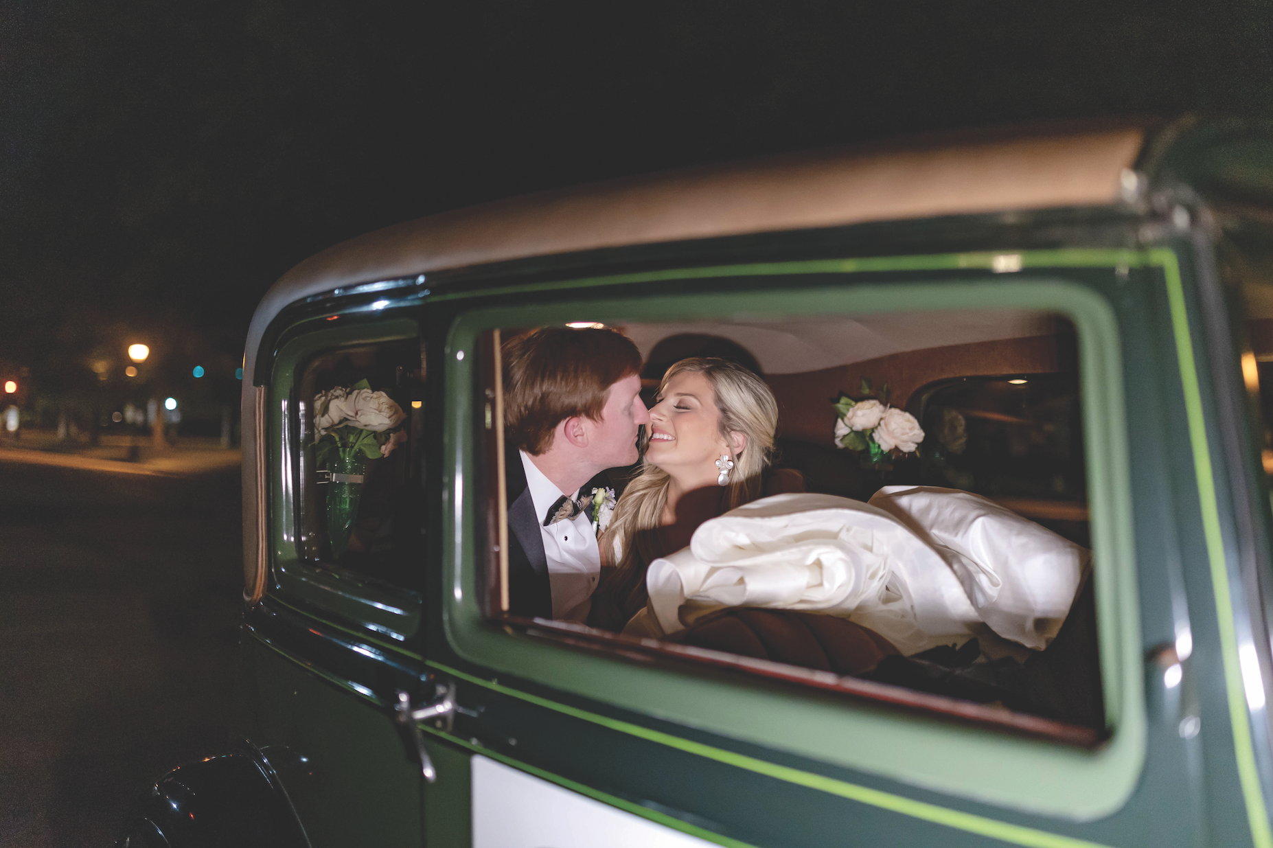 Gabby and Dale in their antique getaway car. Photo: Amy J. Owen Photography, via Augusta Magazine.