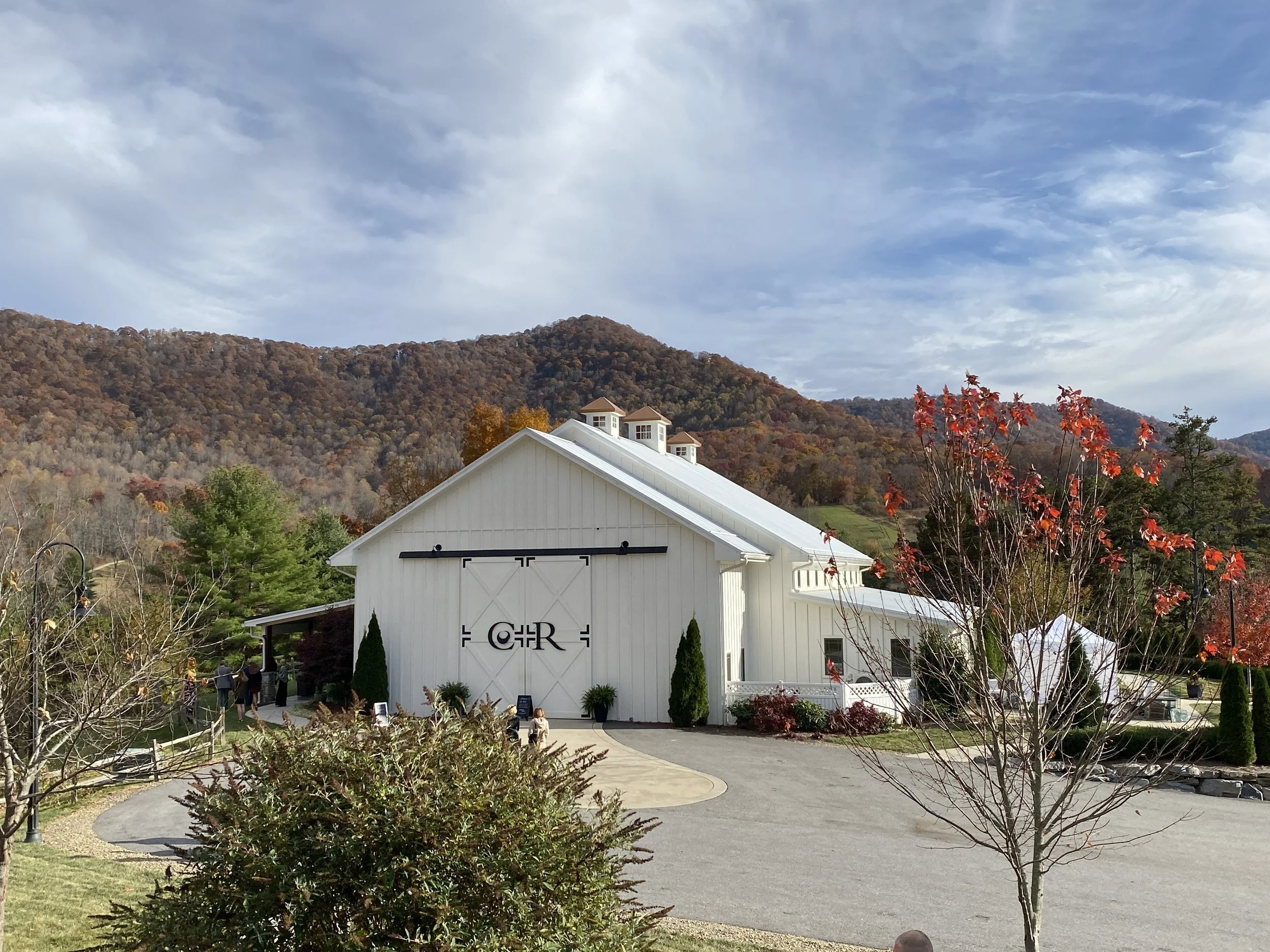 White chapel at Chestnut Ridge with autumn-colored mountains behind it in Canton, North Carolina