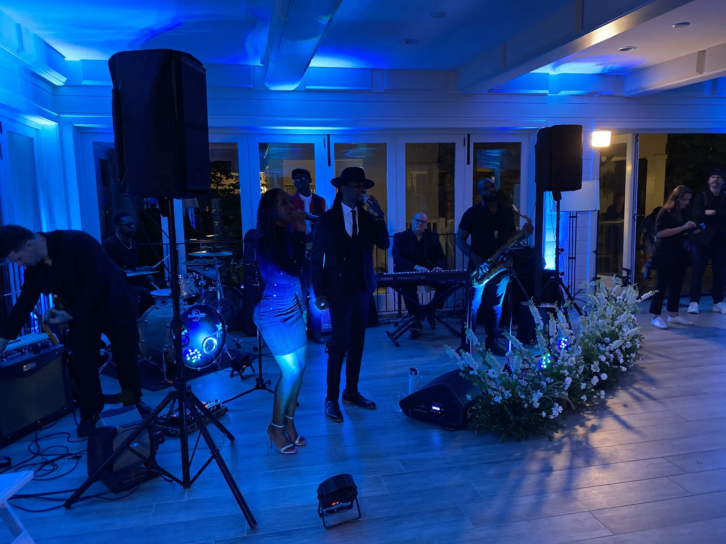 Soulution performing in a blue-lit reception room at Half-Mile Farm in Highlands, North Carolina