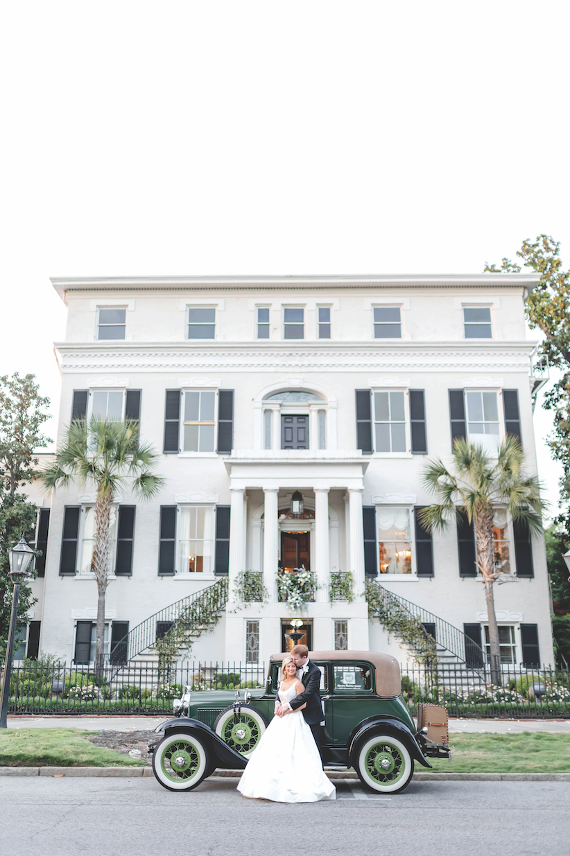 Gabby and Dale beside their antique getaway car at the Marion Hatcher Center. Photo: Amy J. Owen Photography, via Augusta Magazine.