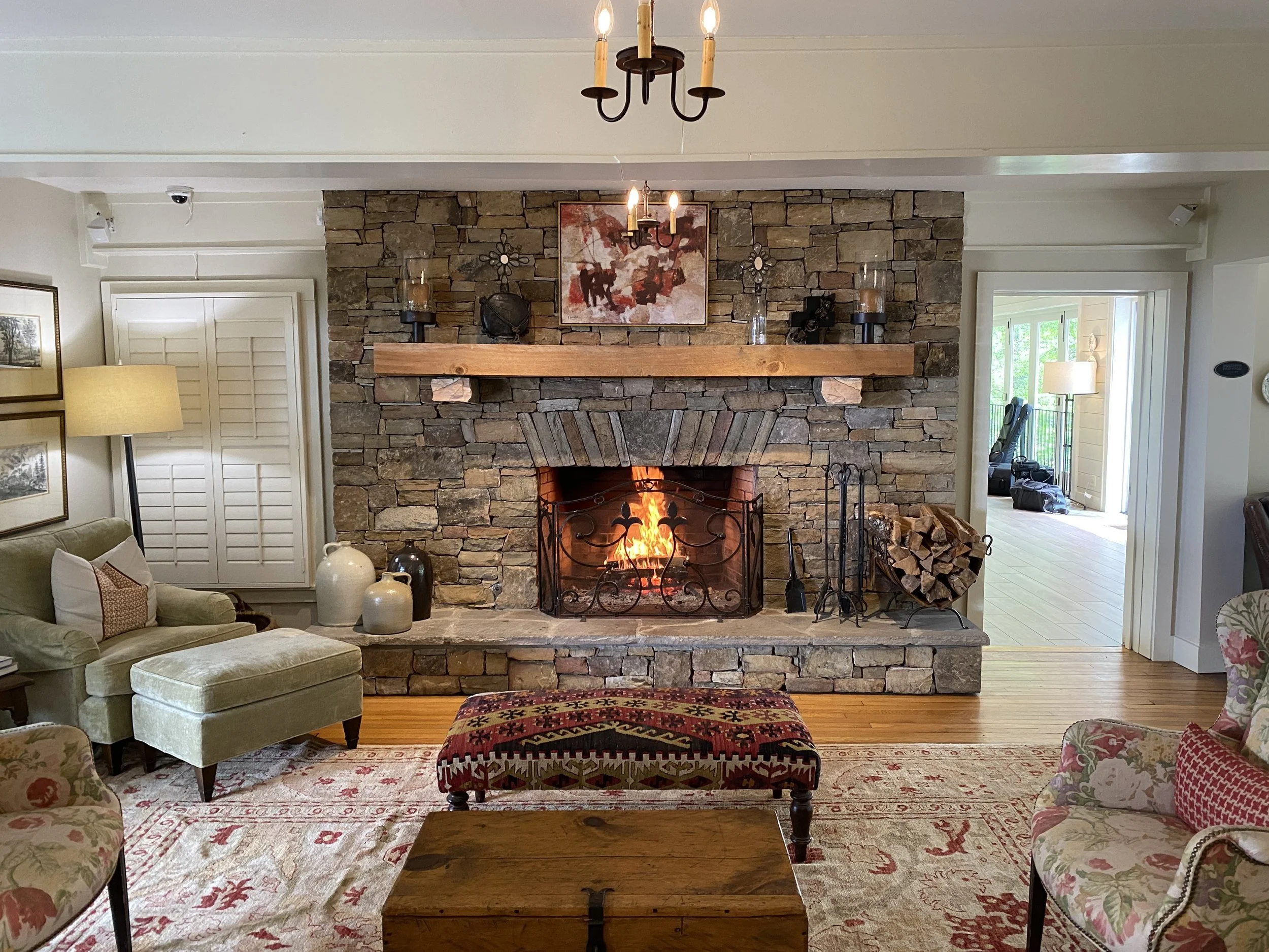 Stone fireplace and lounge seating inside Half-Mile Farm in Highlands, North Carolina