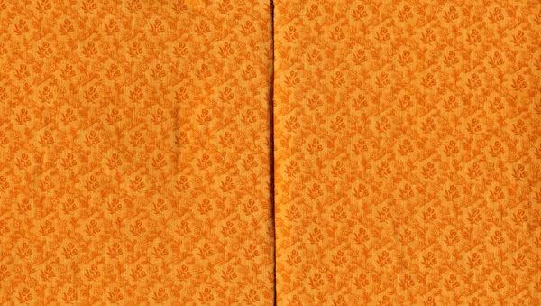 Last spread covered with orange fabric.