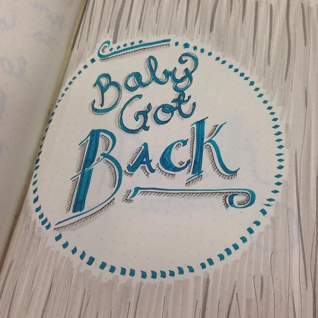Photo of a typographic illustration from "Project 365" that says "Baby got back" in teal with a grey stripe background.