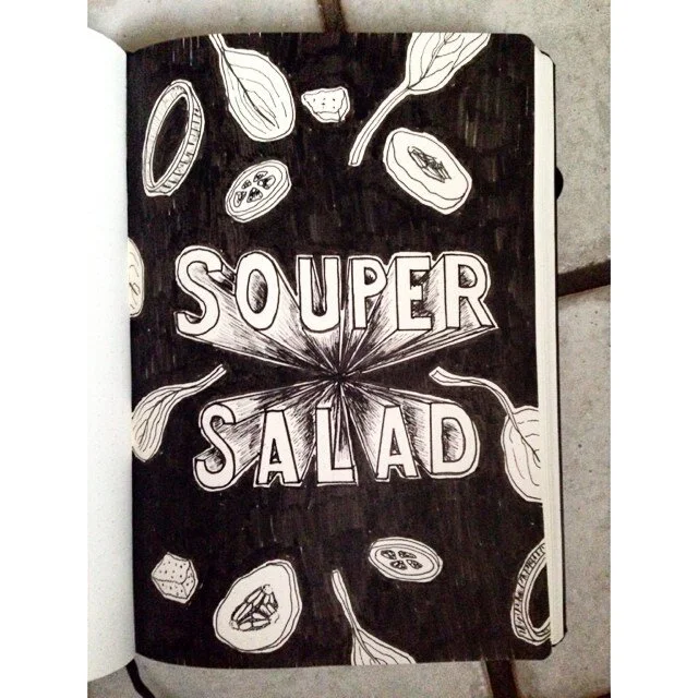 Photo of a typographic illustration from "Project 365": It says "souper salad" with illustrated veggies on a black background