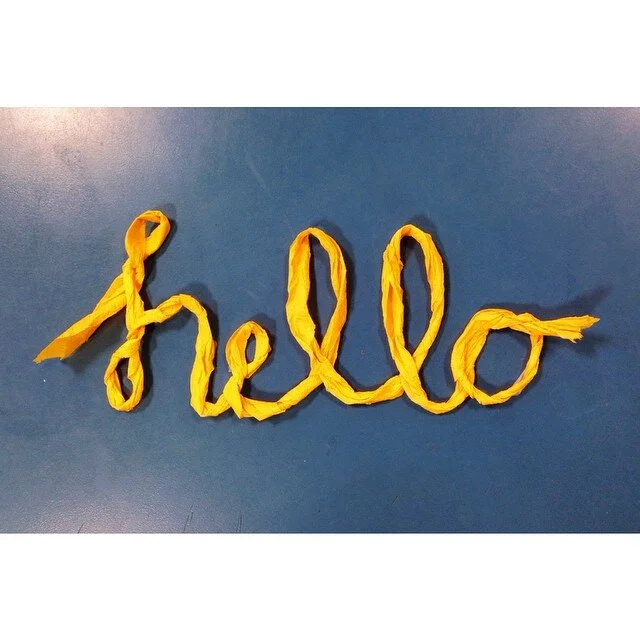 Photo of a typographic illustration using yellow paper that says "hello" - from Project 365.