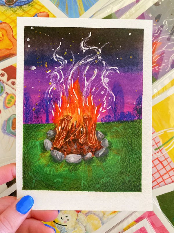 Close up of a burning campfire giving off smoke at dusk. Print measures 5" by 7" and is on recycled stock.