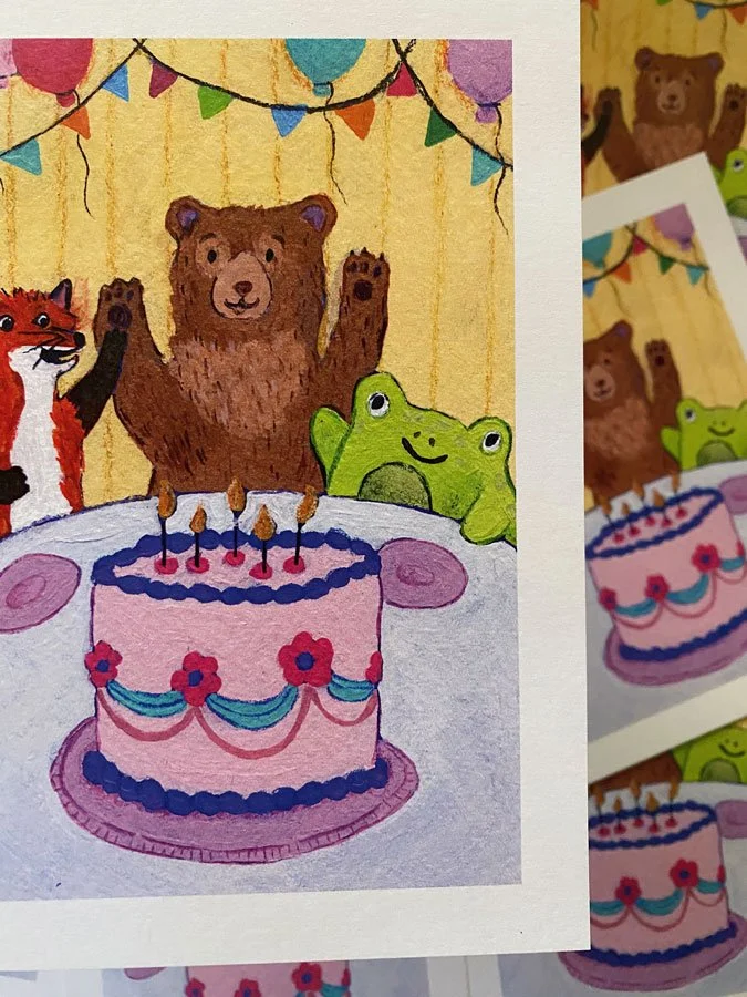 Detail of a happy bear, fox, and frog around a birthday cake with candles. Print measures 5" by 7" and is on recycled stock.