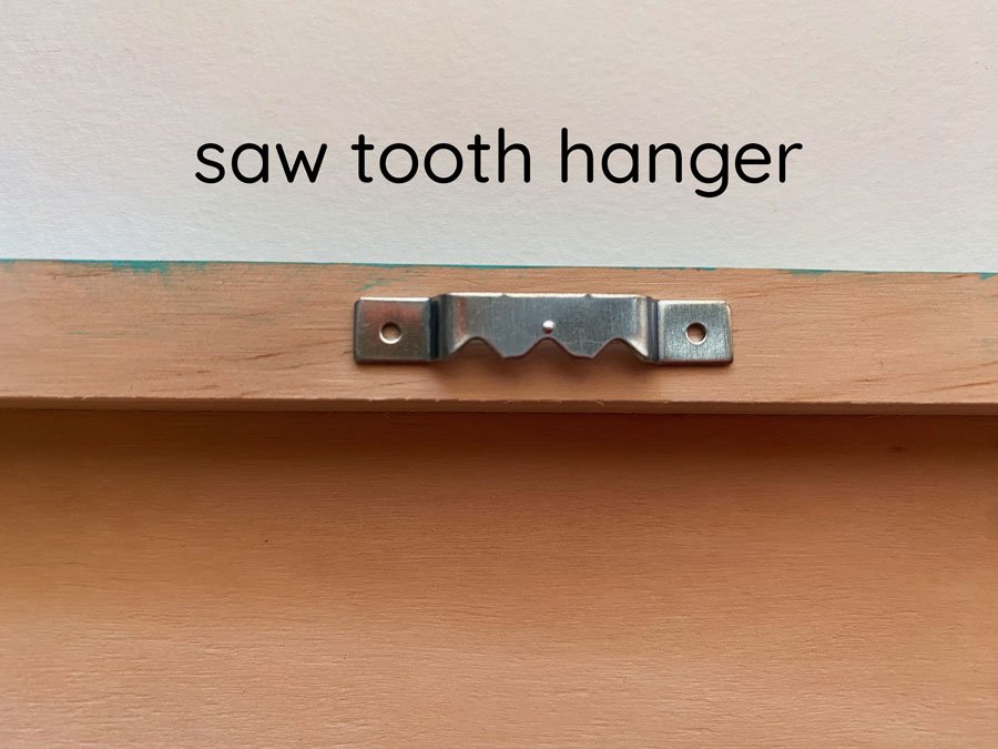 Photo of the back of the wooden panel with a saw tooth hanger option.
