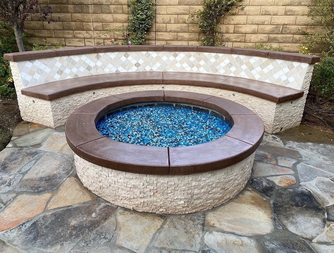 A backyard fire pit we did this summer in Santa Clarita. We added the stone to flow with the existing bbq floor area on the right. With embedded LED lighting along the bench, it will stand out at night with the fire. #h2oconstruction #santaclarita #f