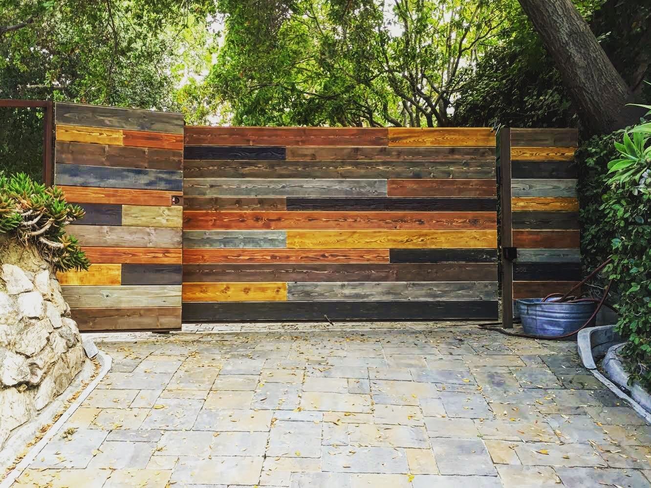 #throwbackthursday || We created this custom automated gate for a longtime client of ours. The vision was reclaimed materials. All the panels are stained and painted individually to accomplish our clients goals&mdash; to have something unique and ind