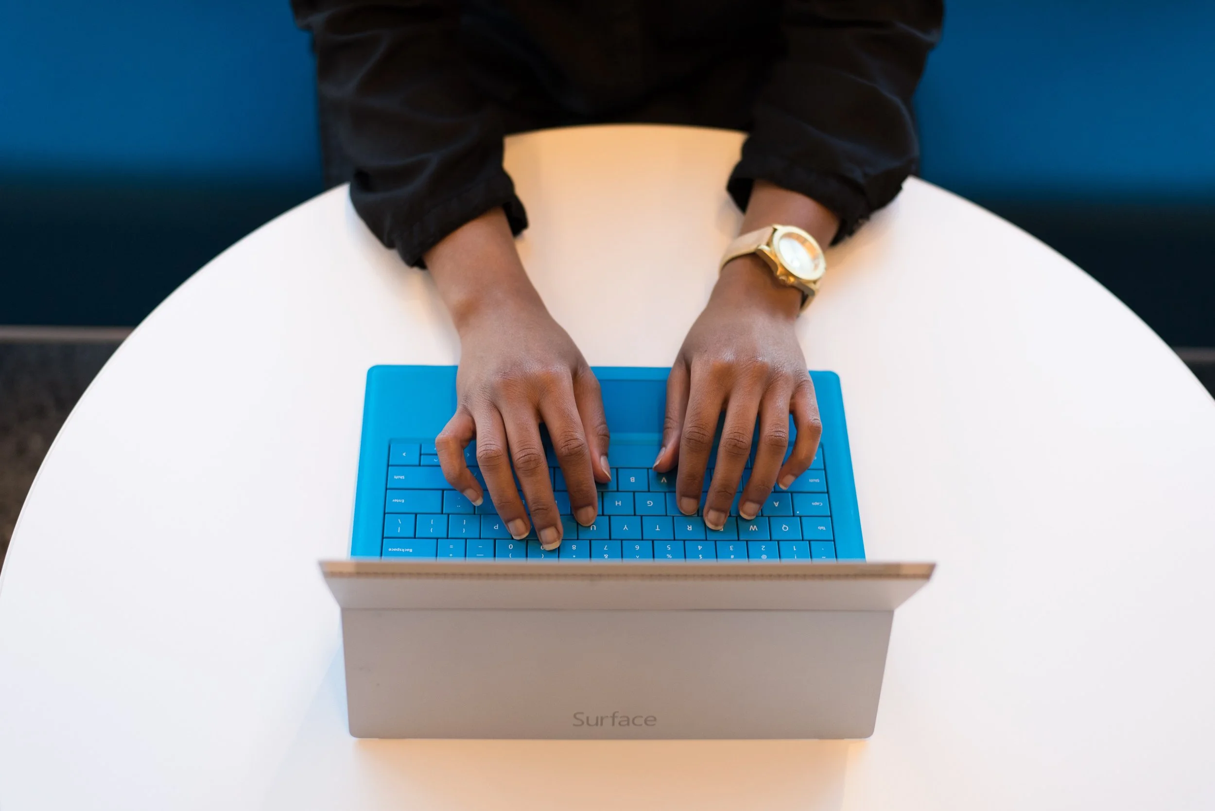 hands typing on a laptop