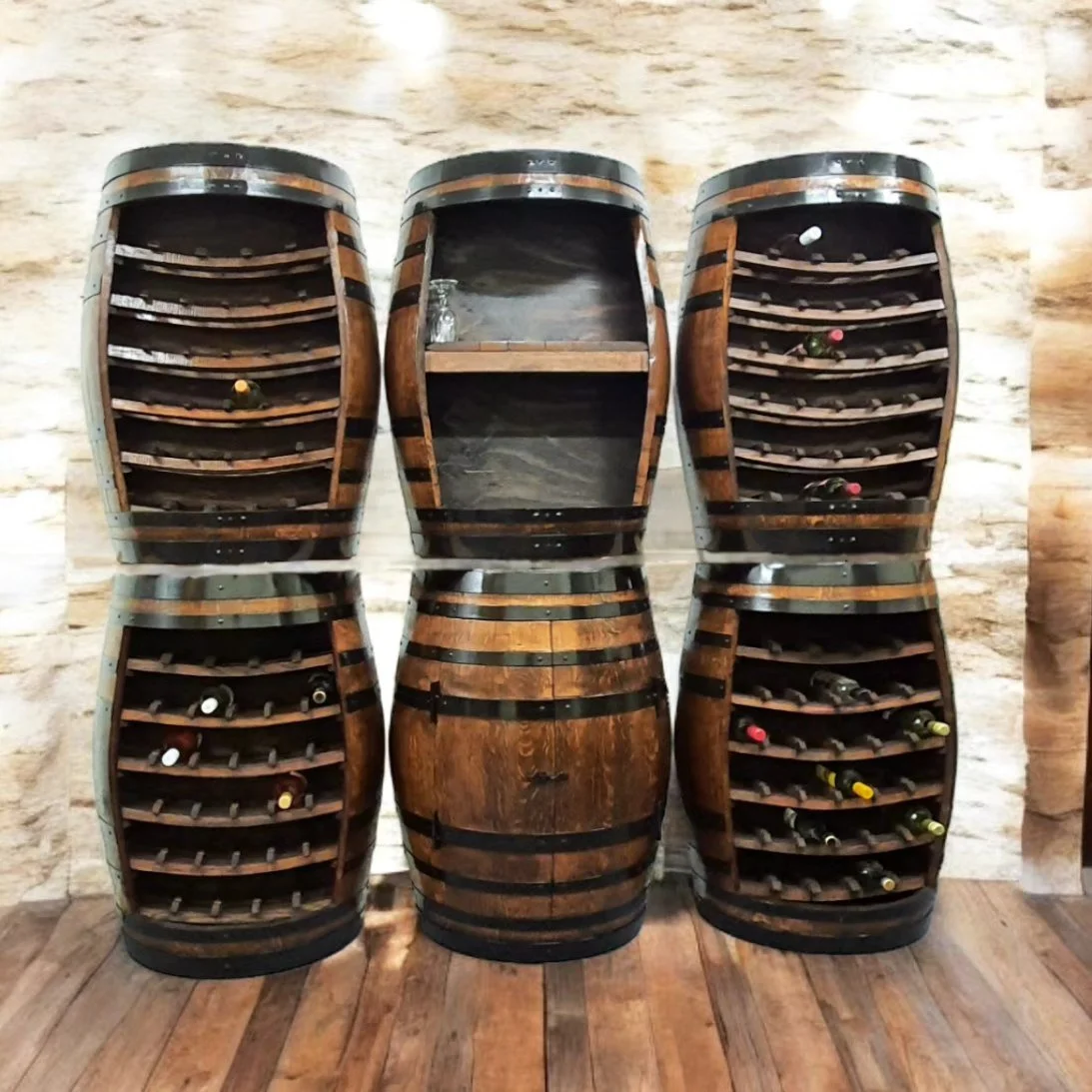 Unique wine rack made from repurposed barrels, holding several bottles of wine in a rustic setting.