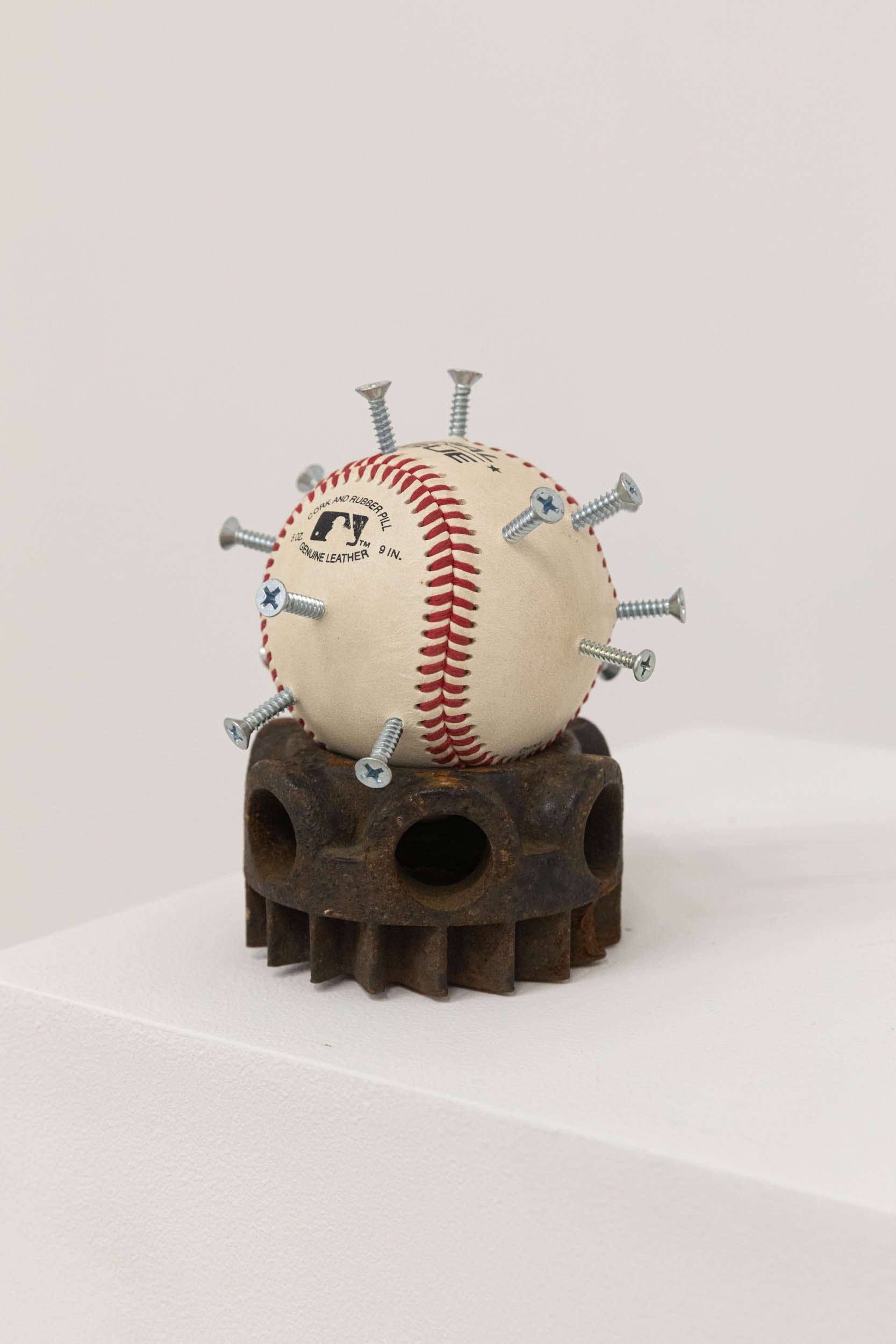 Garrett Fuller 
 Popov and SunnyD , 2026 
1" screws, autographed baseball, gear from the mill yard found on 42nd and Charlotte Ave 
IN12009