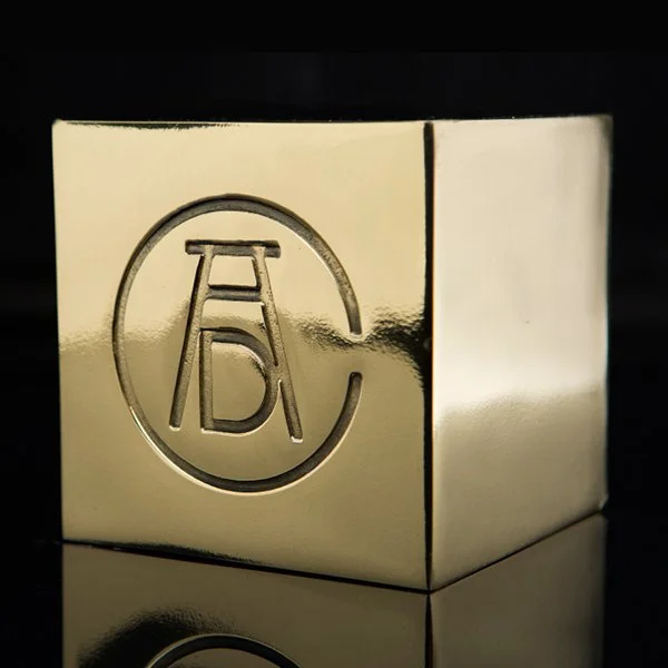 Gold cube with embossed circle and ladder design