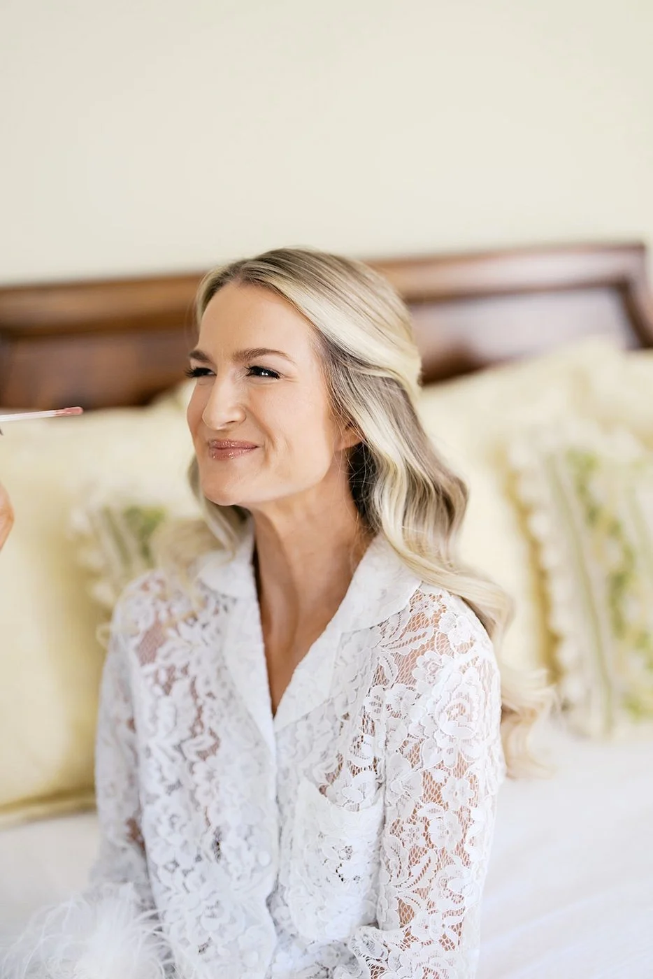 close up picture of a bridal getting the final touches of her wedding makeup