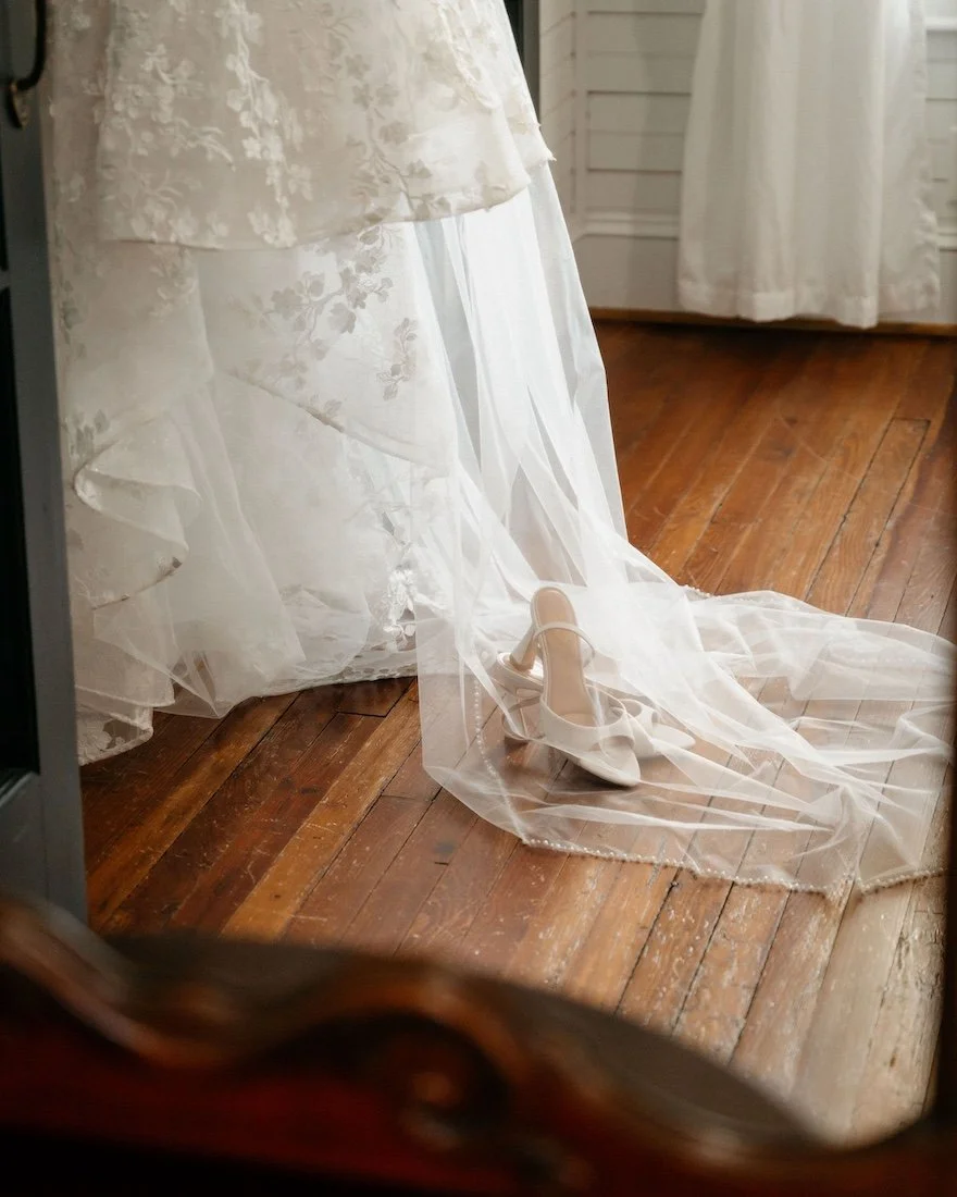 bridal dress and wedding shoes places on timeless hardwood floors