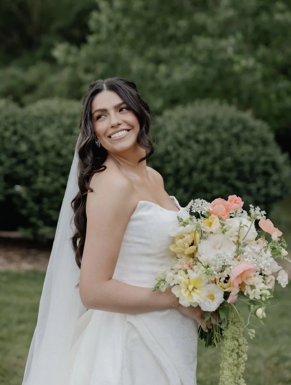 brunette bride holding an elegant bouquet arrangement in her wedding dress