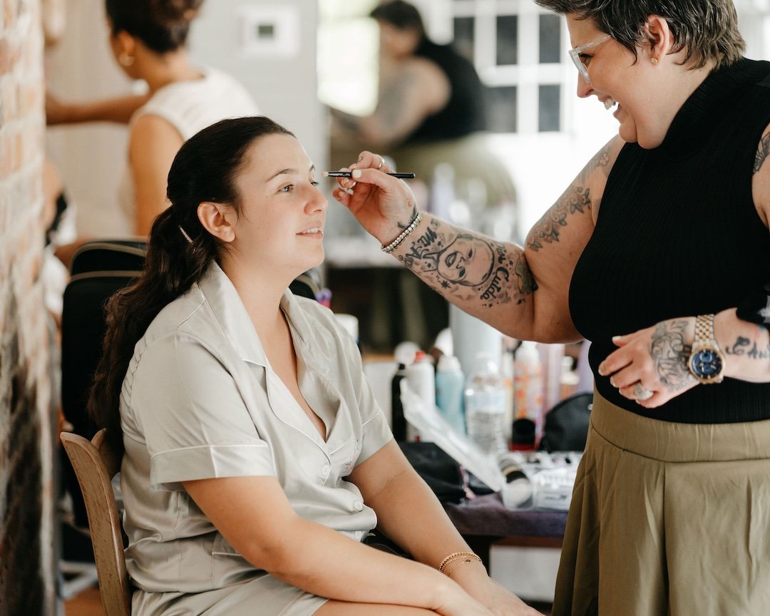 two women laughing and playing in makeup